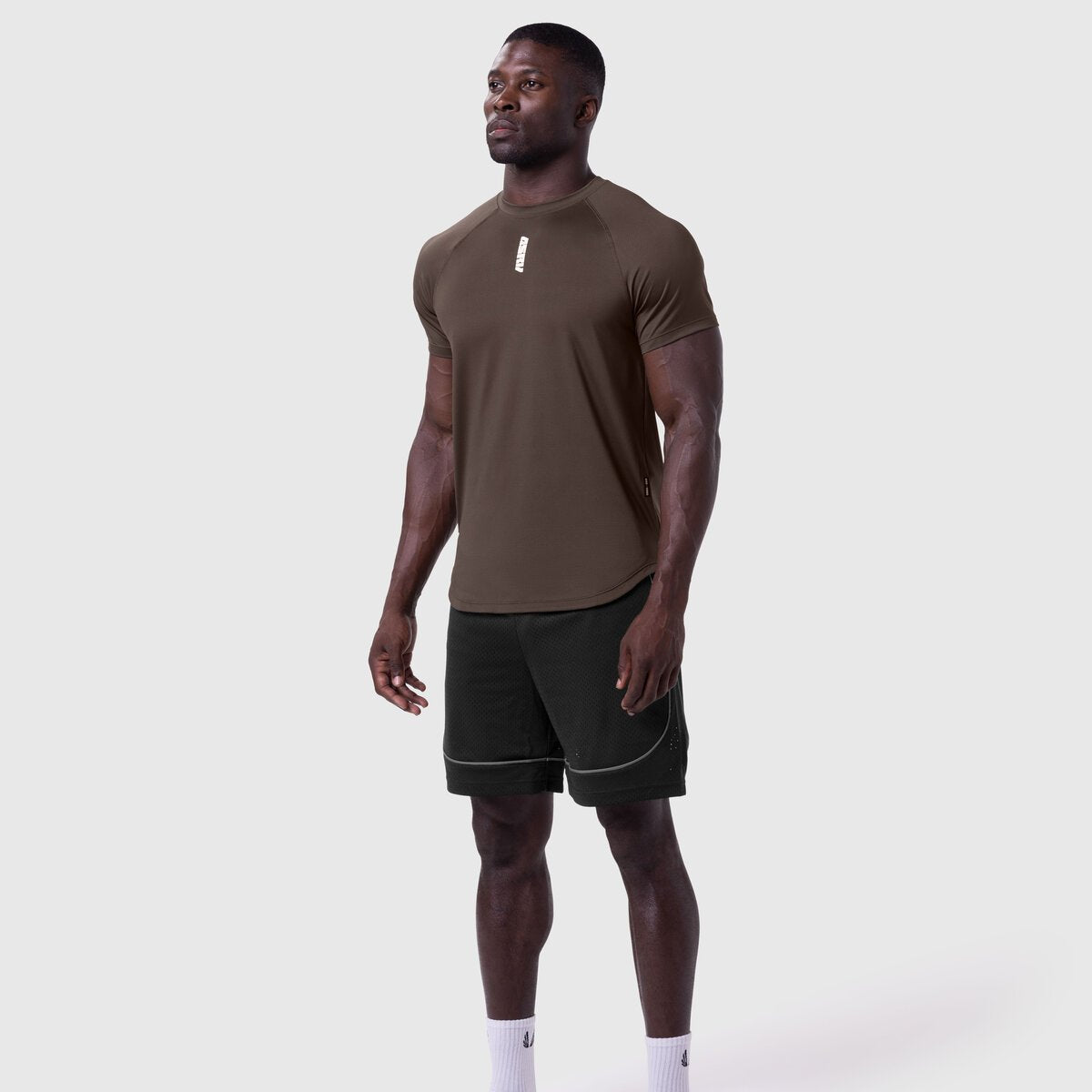 AeroSilver Established Tee in dark earth worn with black shorts, front view on model