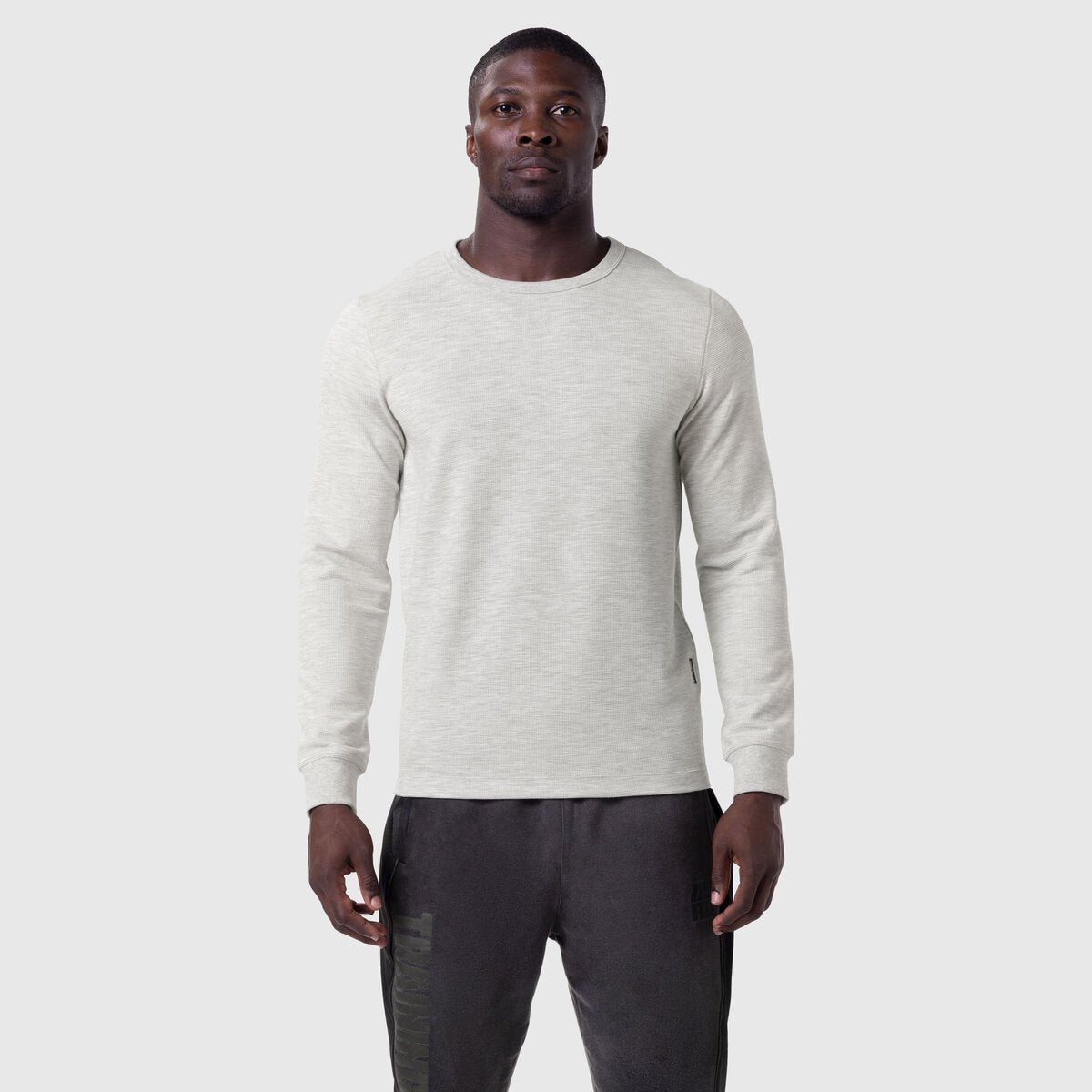Waffle knit longsleeve in heather grey worn by model with dark joggers, front view