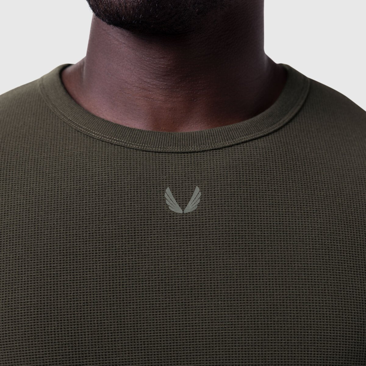 Olive waffle knit longsleeve on model, front view showing chest logo detail