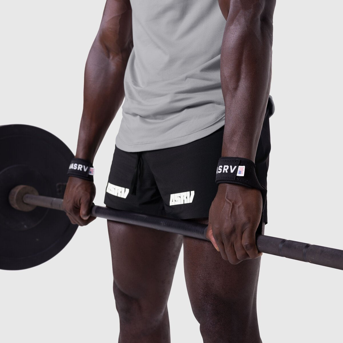 Padded Lifting Straps in black worn on wrists while holding barbell, front view