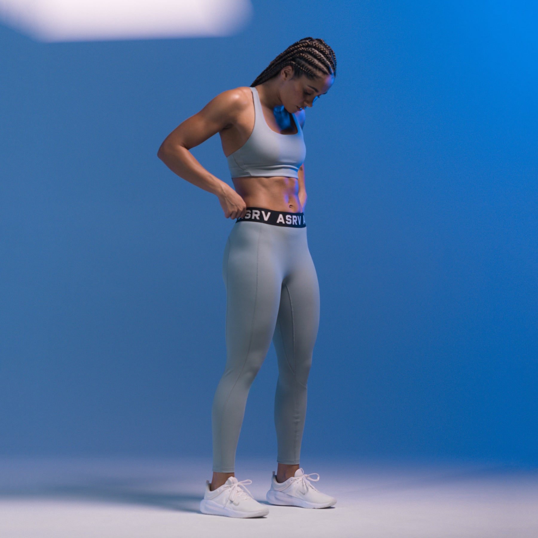 W071 Lycra Ribbed Legging in light sky, worn by model standing against blue background