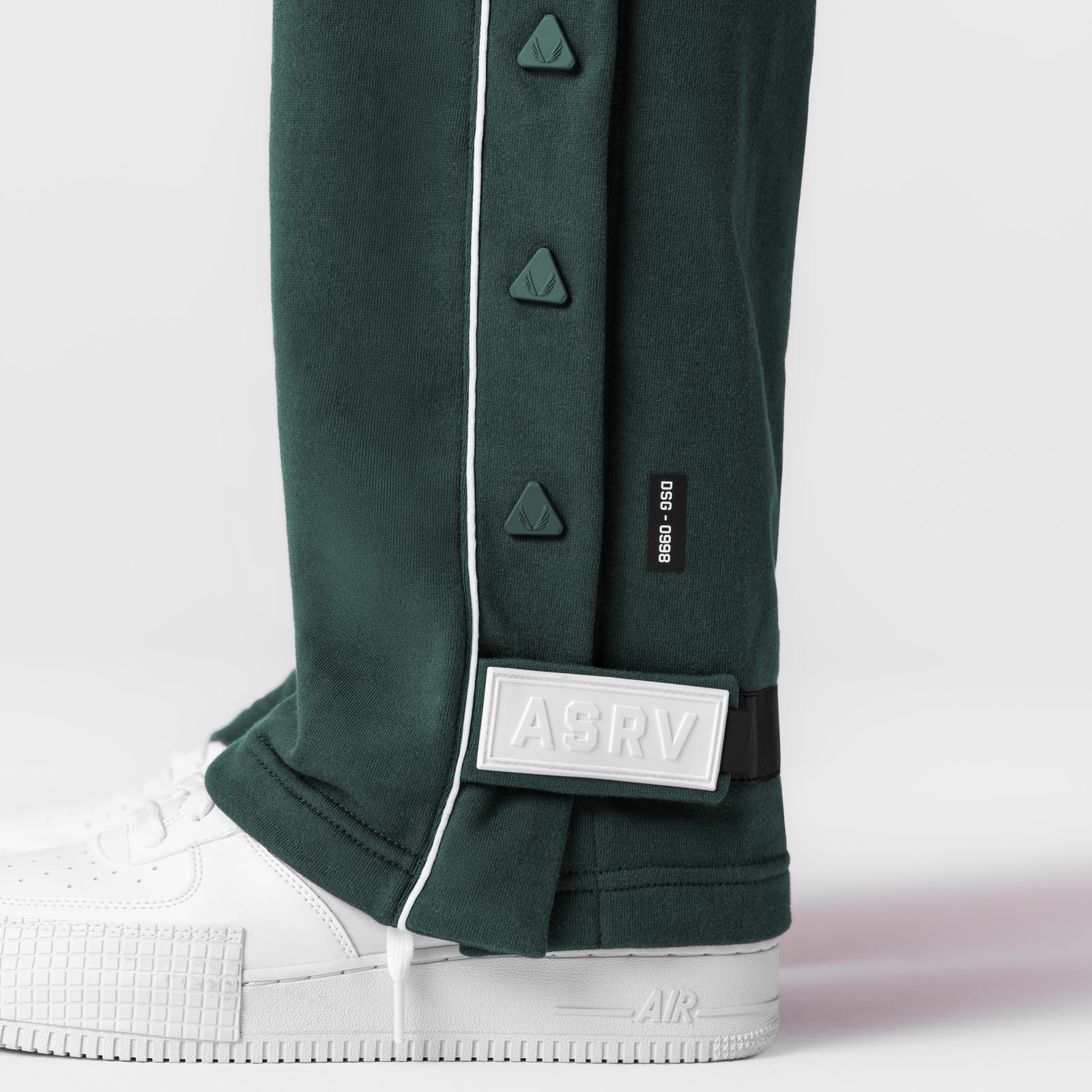 Herringbone Terry Snap Button Sweats in forest green, worn with white sneakers, detail view