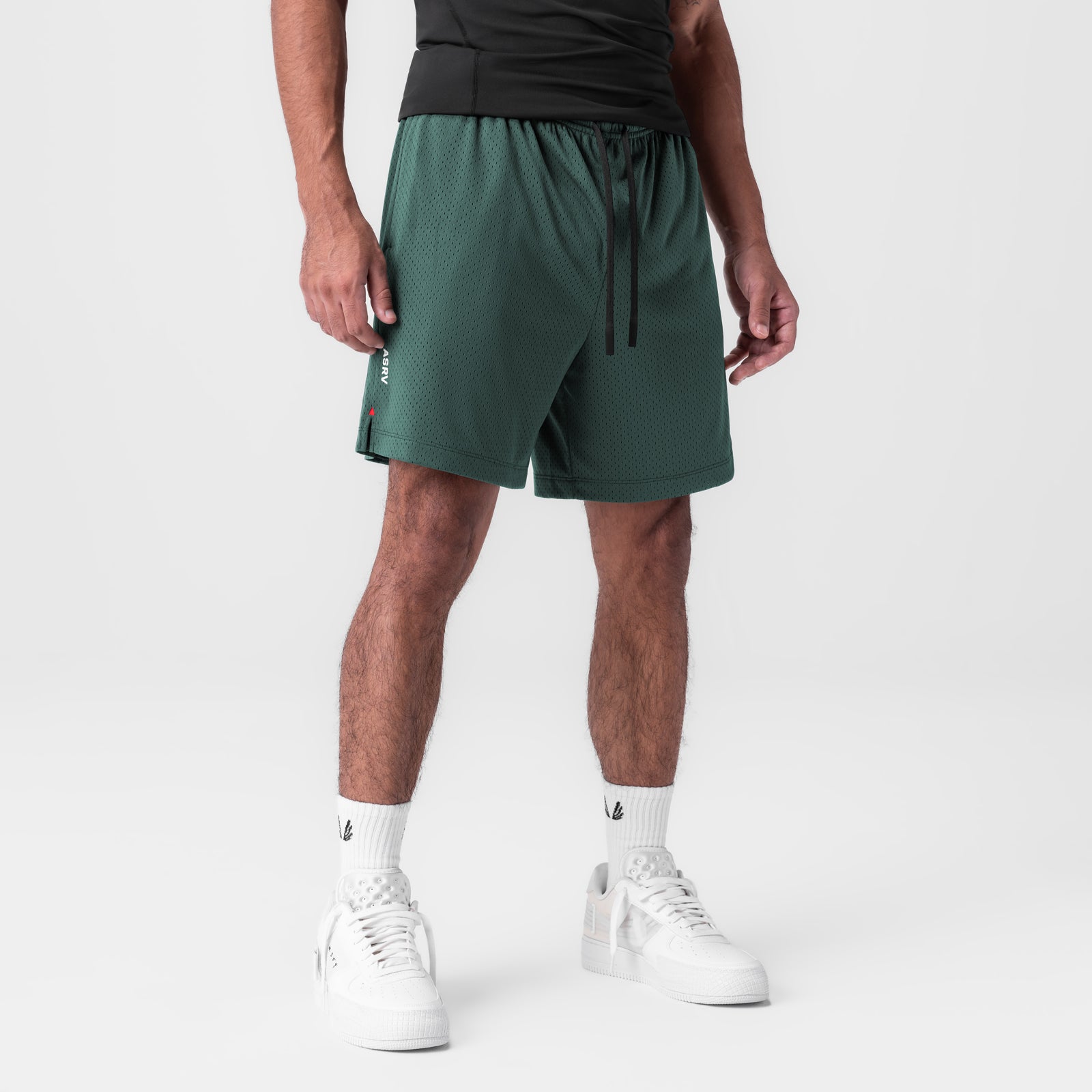Reversible 2-in-1 shorts in forest green worn by model, front view