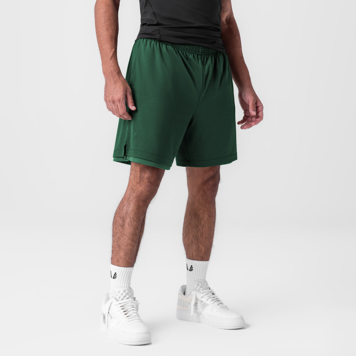 Reversible 2-in-1 Short in forest green worn by model with white sneakers, front view