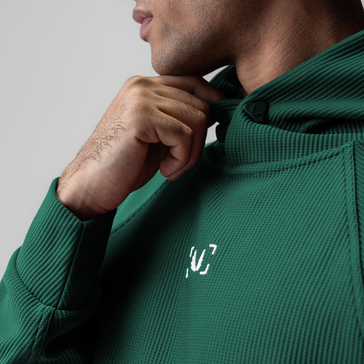 Deltapeak® Oversized Hoodie in forest green, worn by model showing chest logo detail