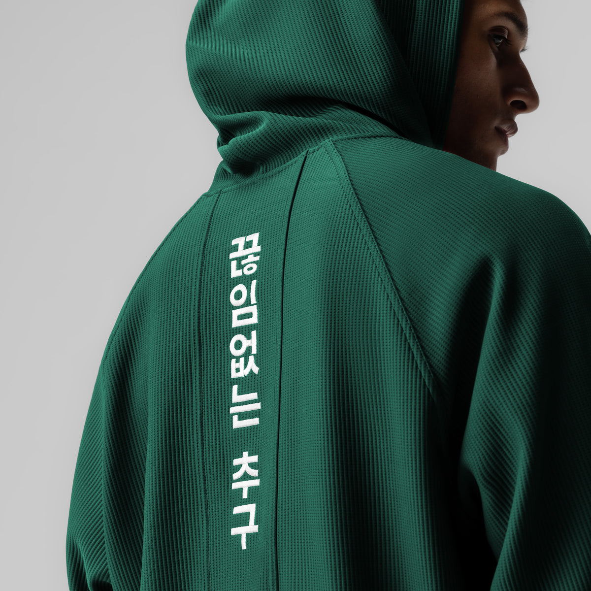 Deltapeak® Oversized Hoodie in forest green worn by model, back view showing Korean text