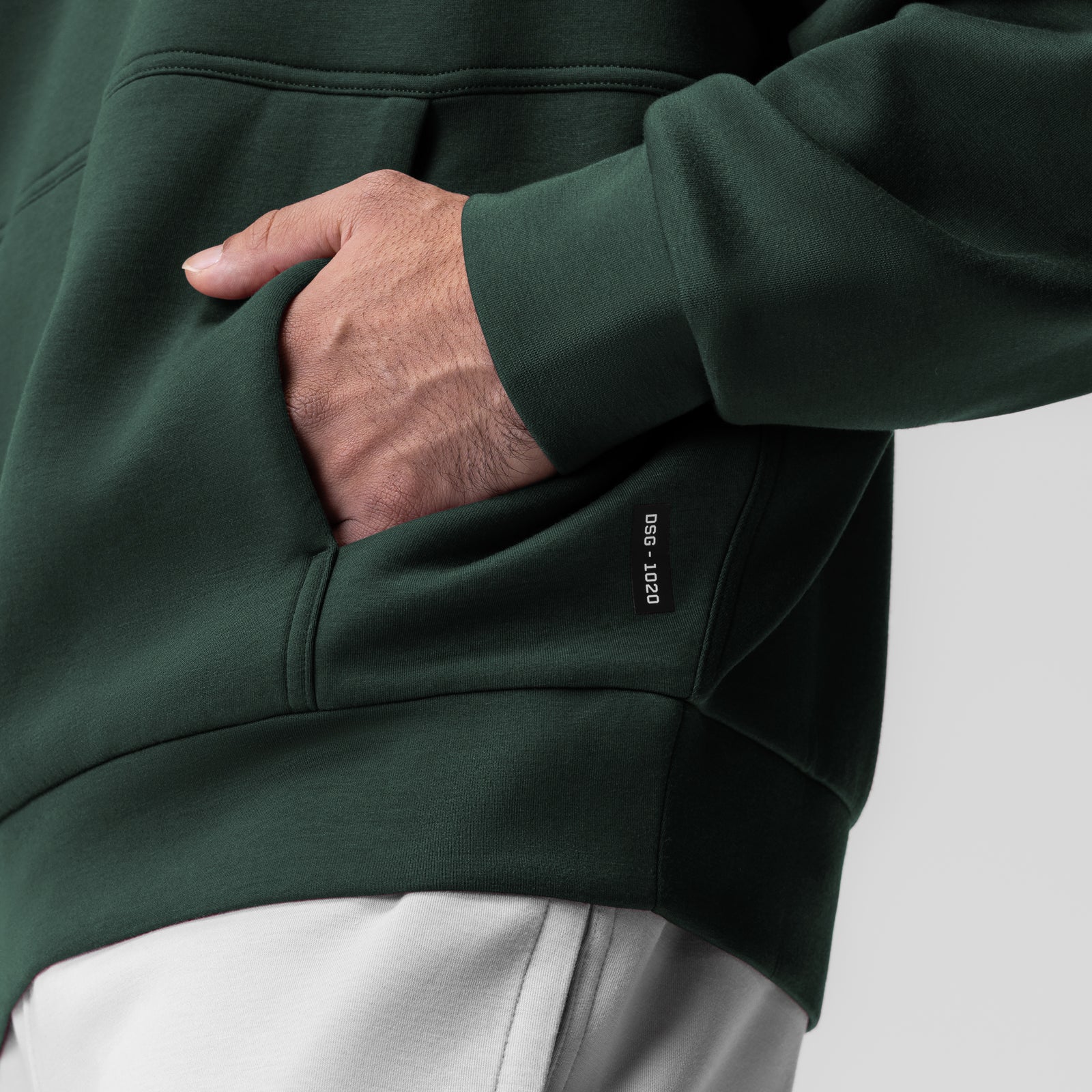 Dri-Core oversized crewneck in forest green, model wearing with hand in pocket