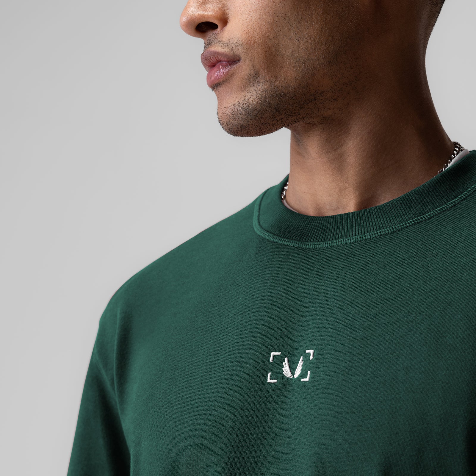 Herringbone Terry Oversized Cinch Tee in forest green, worn by model in profile view