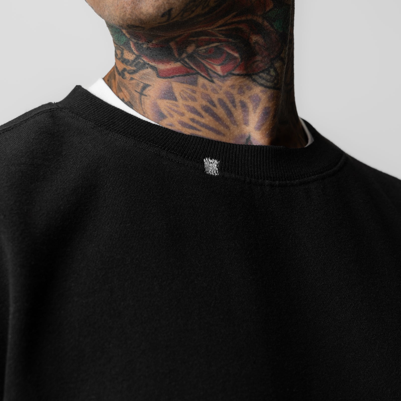 Black Tech Essential Distressed Crewneck worn by model, showing neckline detail and fit