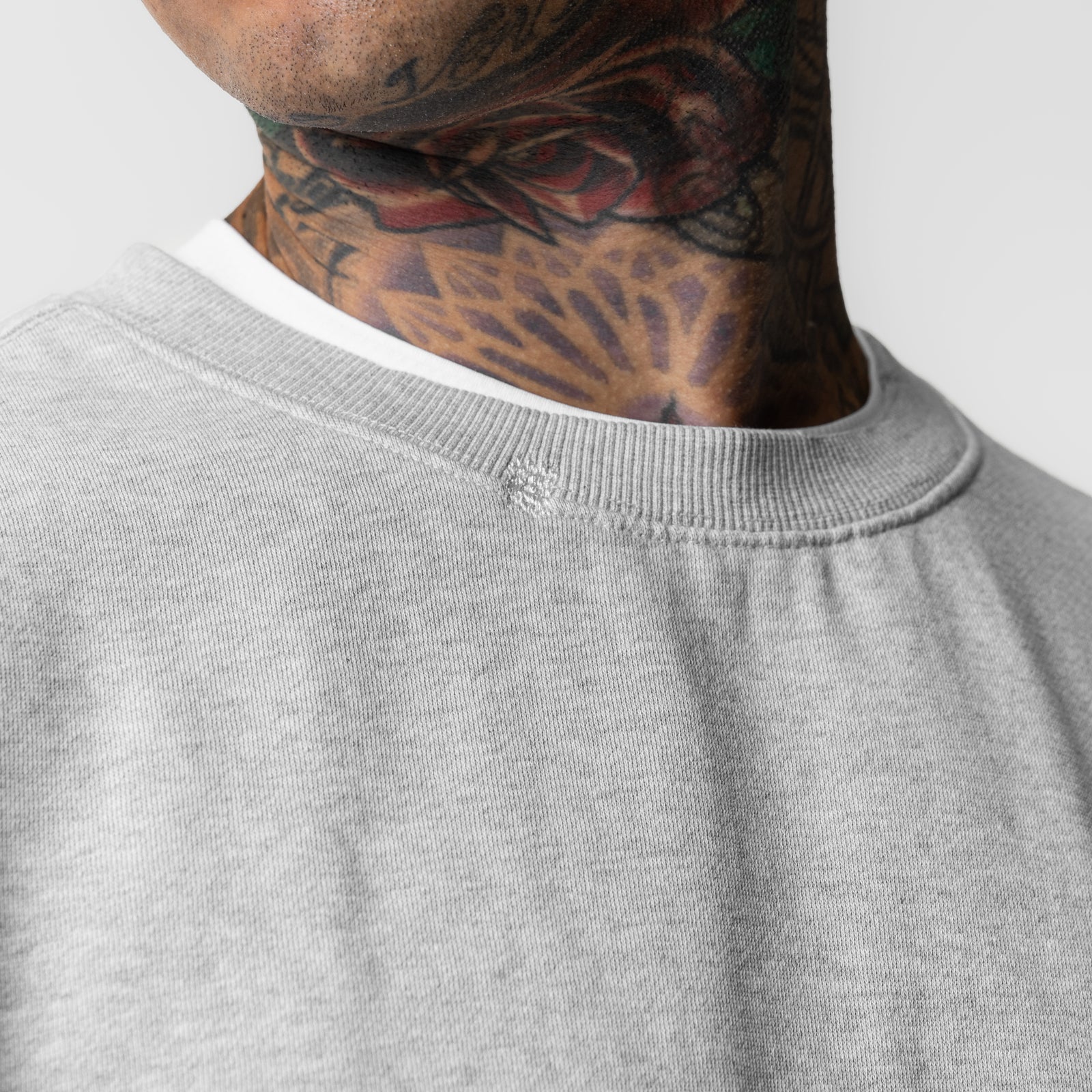 Tech Essential Distressed Crewneck in heather grey, worn by model showing neckline detail