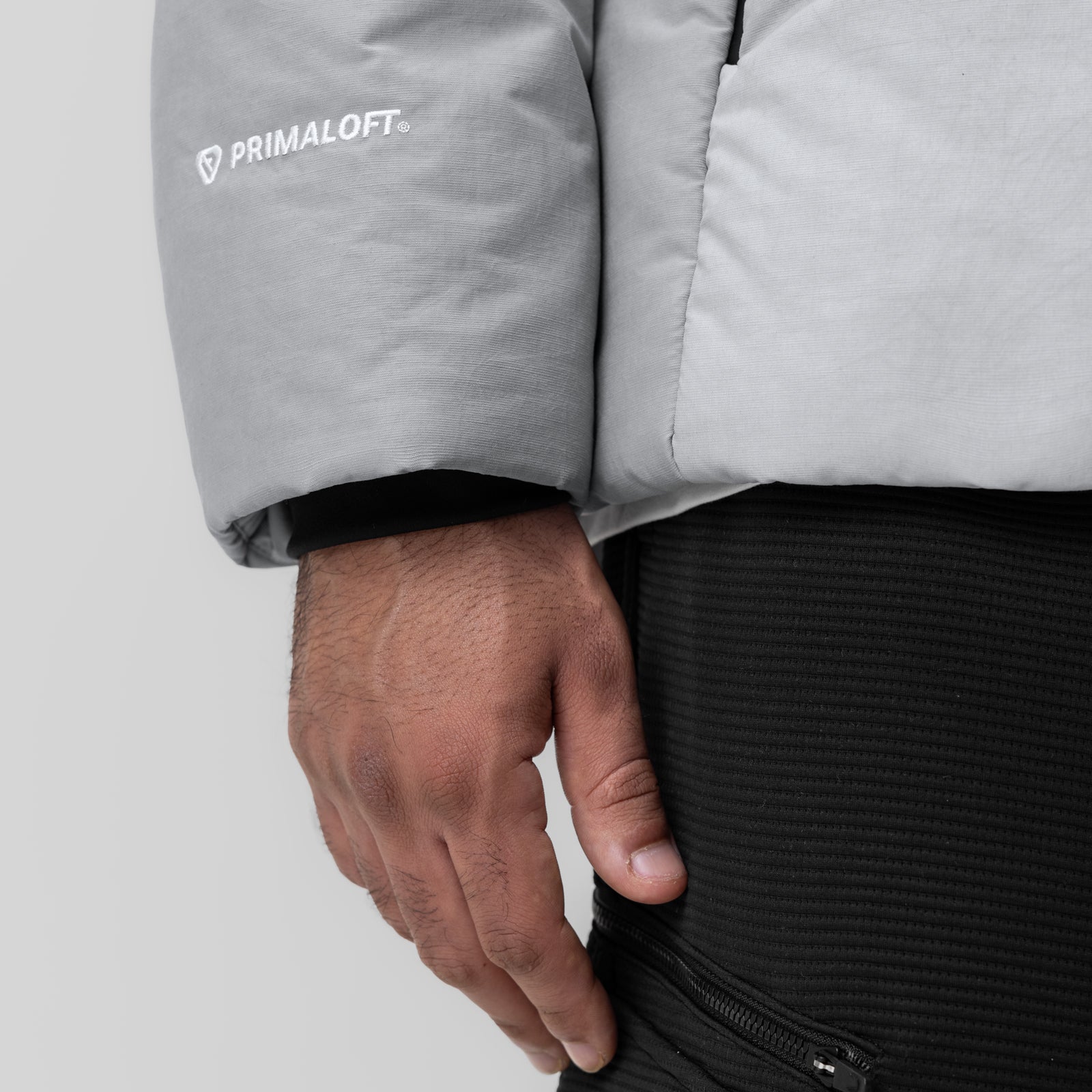 PrimaLoft Weather-Ready Puffer Jacket in grey, worn by model showing sleeve and side detail