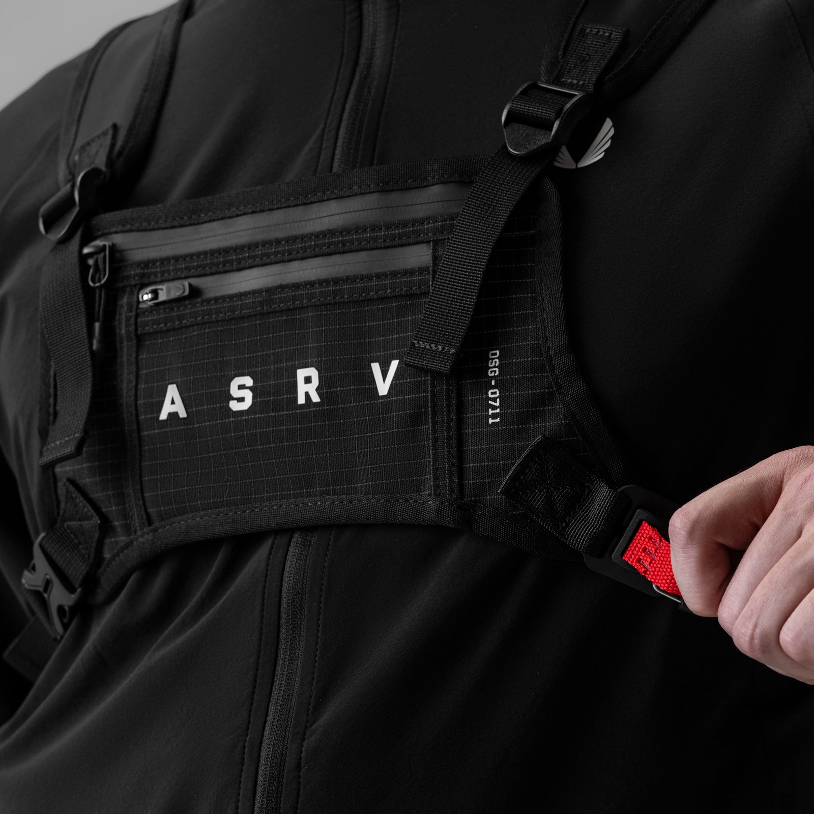 0711 Cordura Lightweight Chest Pack in black grid, worn and held by model