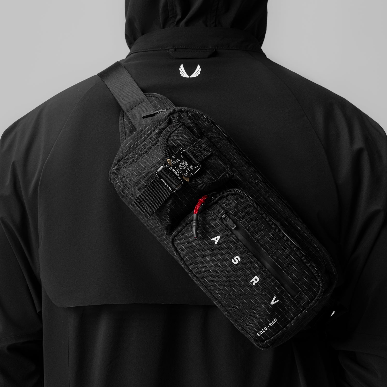0703 Cordura Tech Crossbody Pack in black grid, worn across back