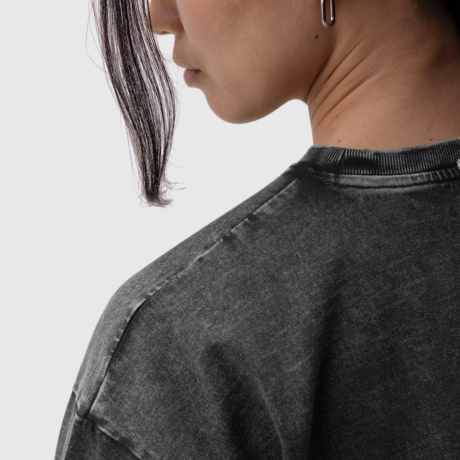Distressed Relaxed Tee in black, worn by model in profile view