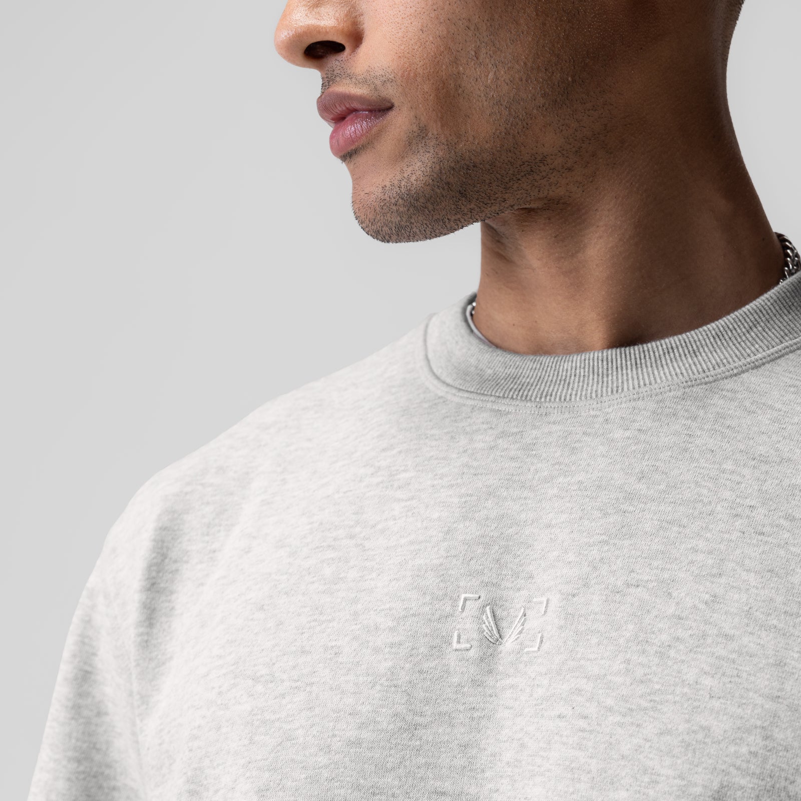 Herringbone Terry Oversized Cinch Tee in heather grey, worn by model in profile view