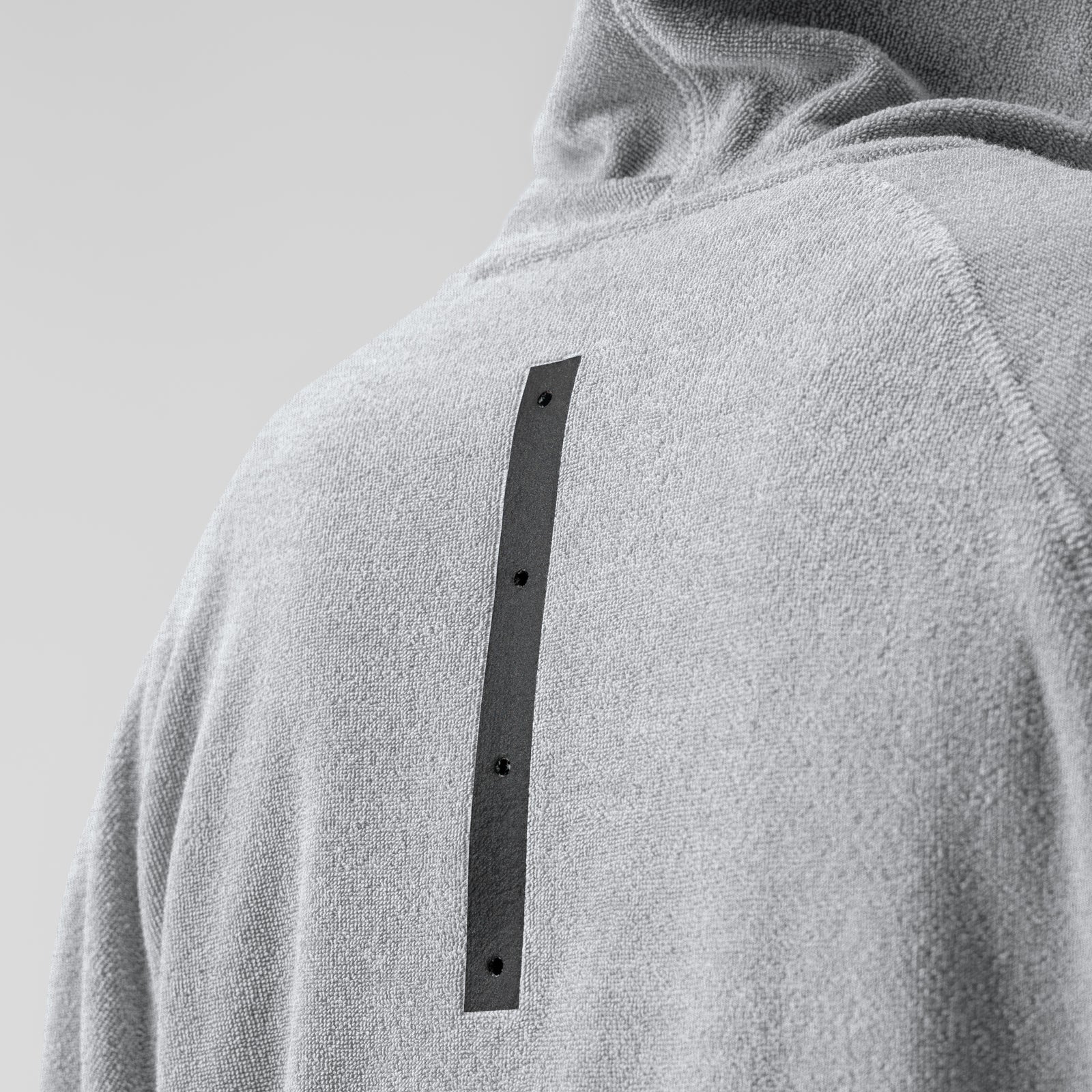 Towel Terry Reversible Hoodie in Heather Grey worn by model, back view showing detail strip