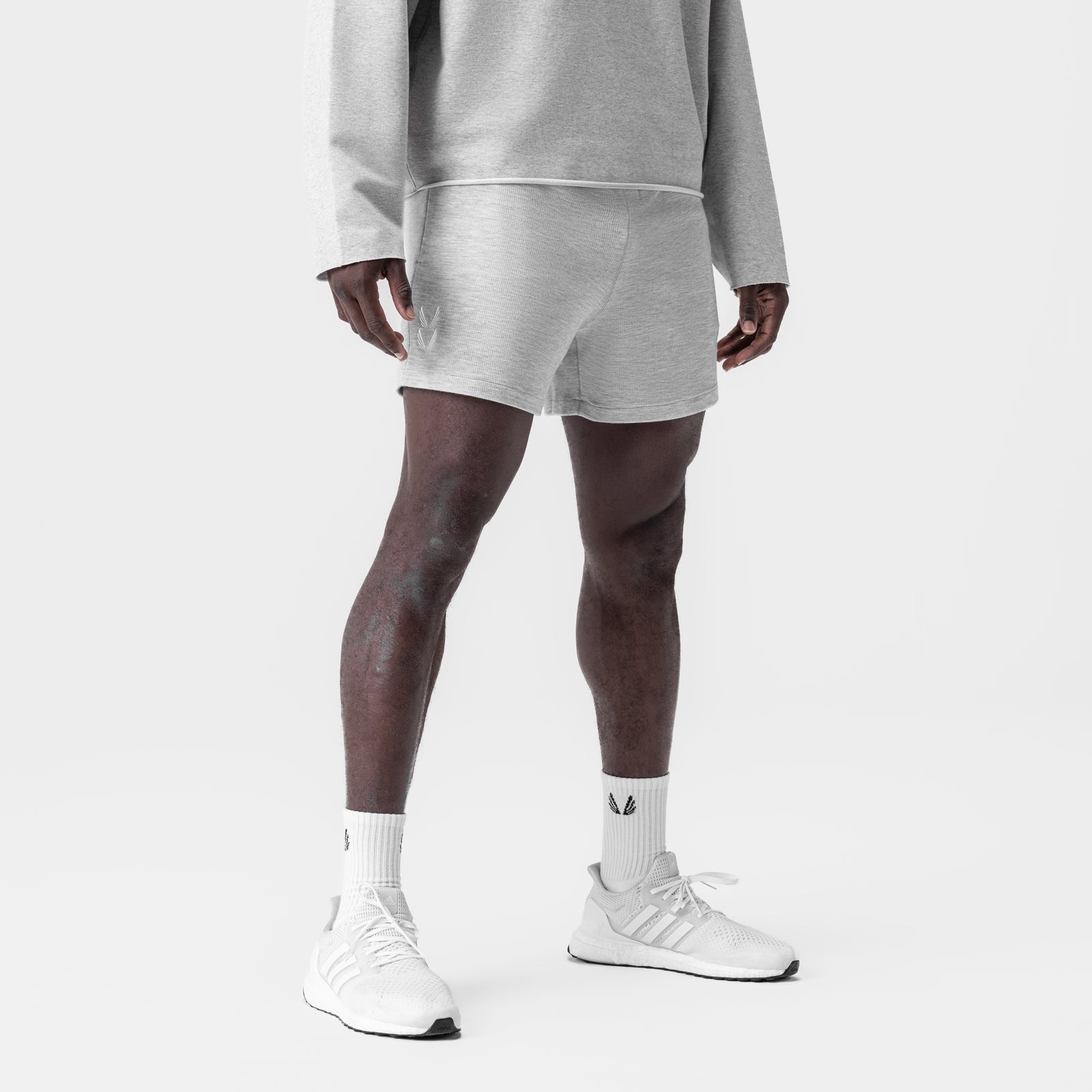 Heather grey waffle knit sweat shorts worn with matching hoodie, front view on model