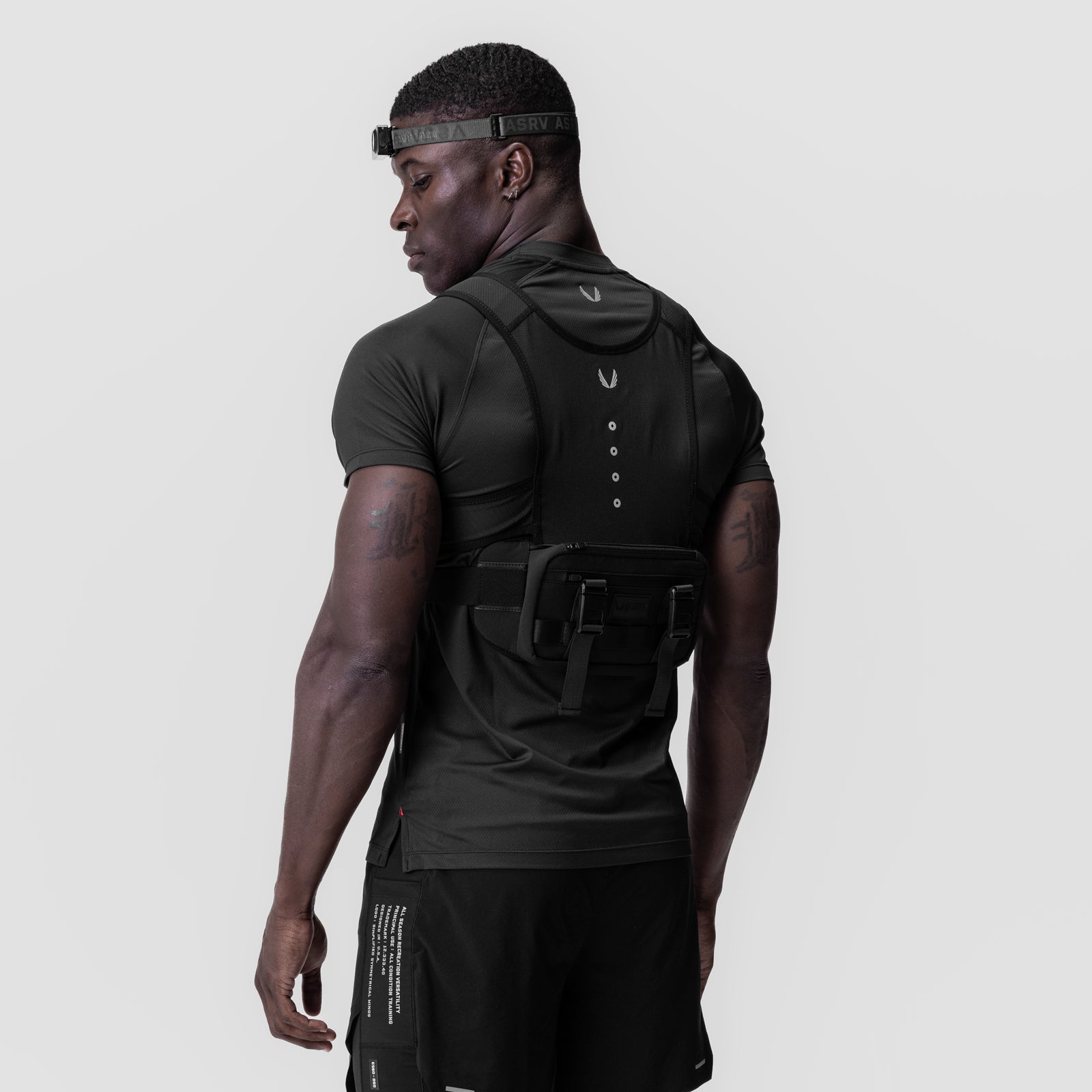 Black ASRV x Bookman Monocle hooded vest worn by model, back view
