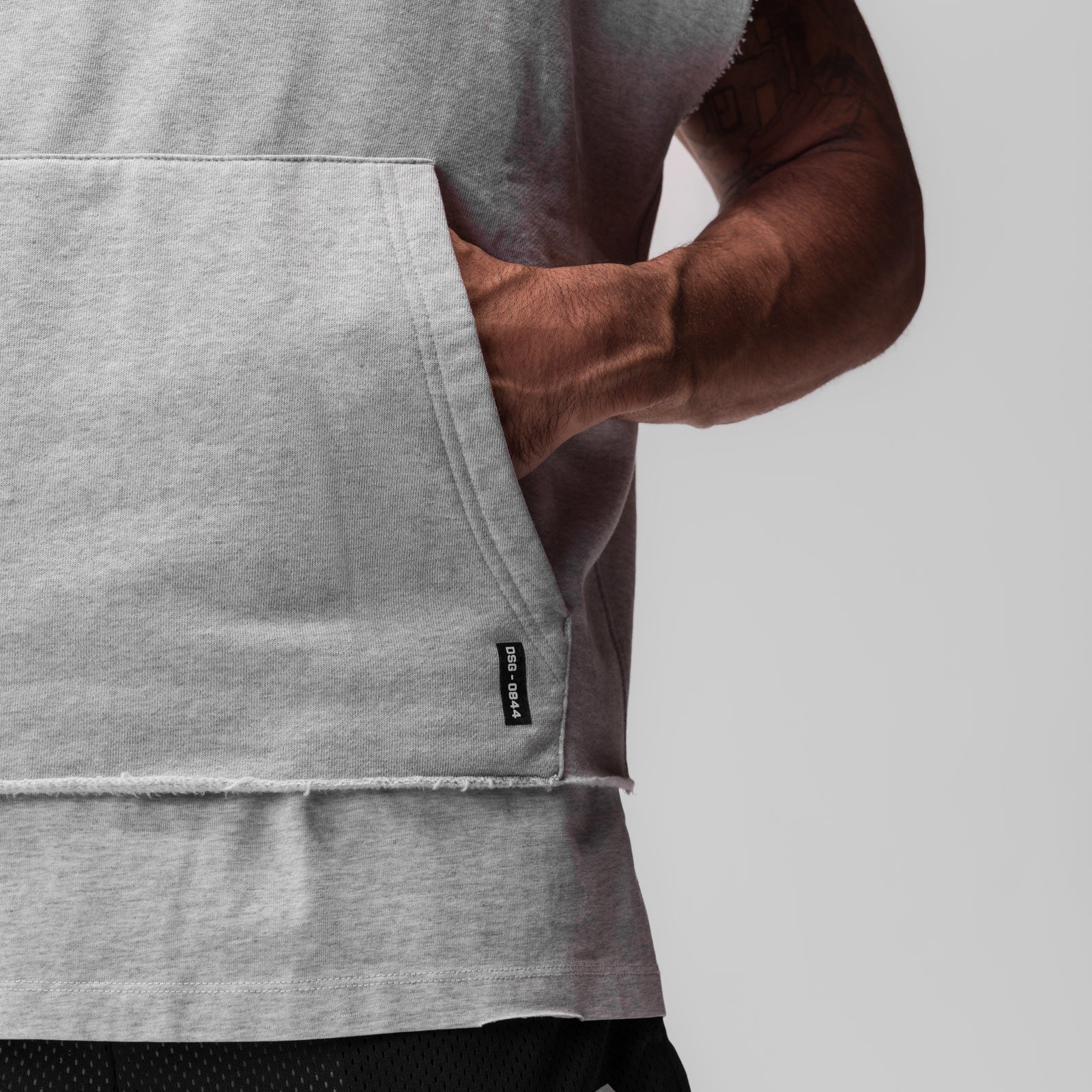 Tech Essential Raw Hem Cutoff Hoodie in heather grey, worn by model, side view