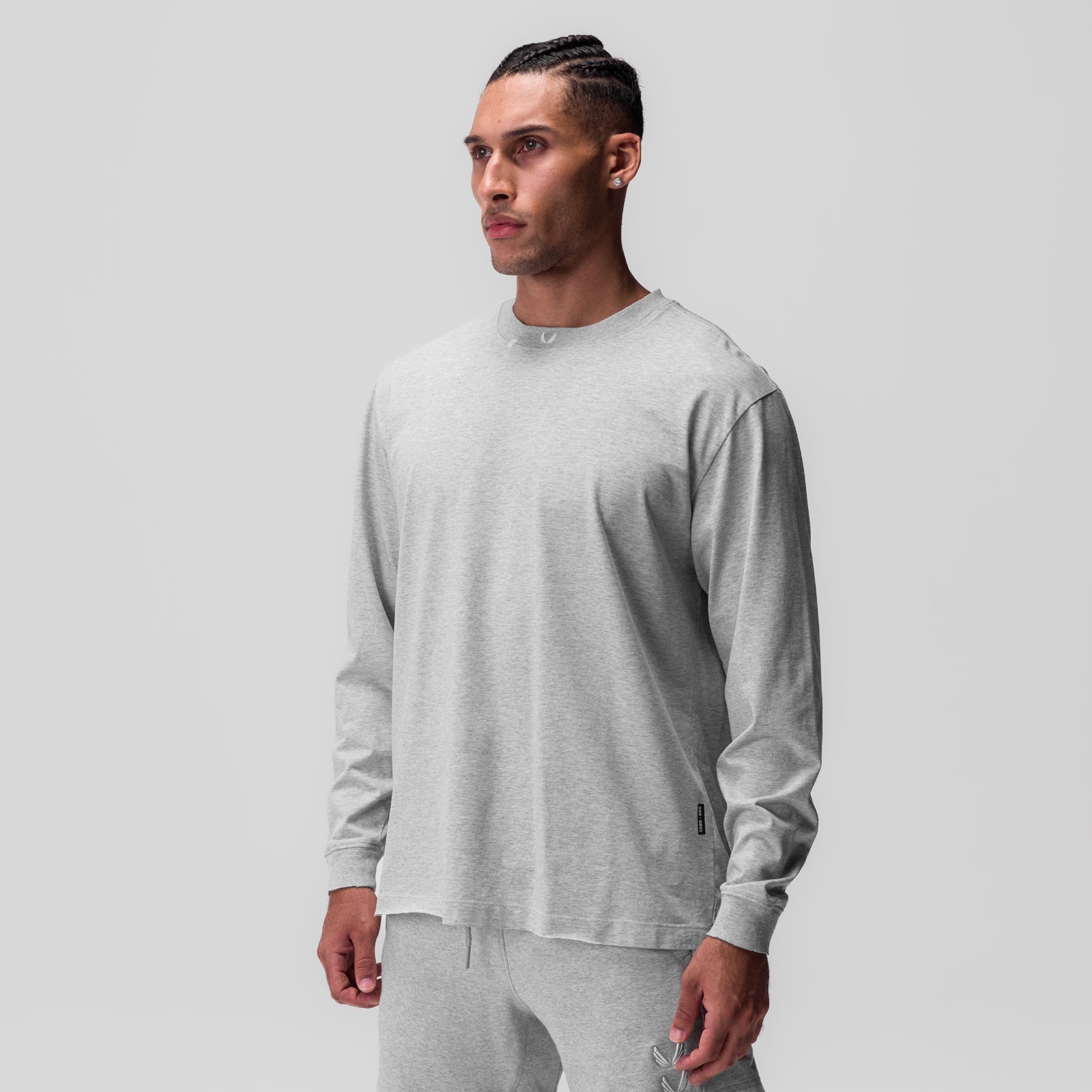 Tech Essential Relaxed Long Sleeve in heather grey, worn by model in front pose