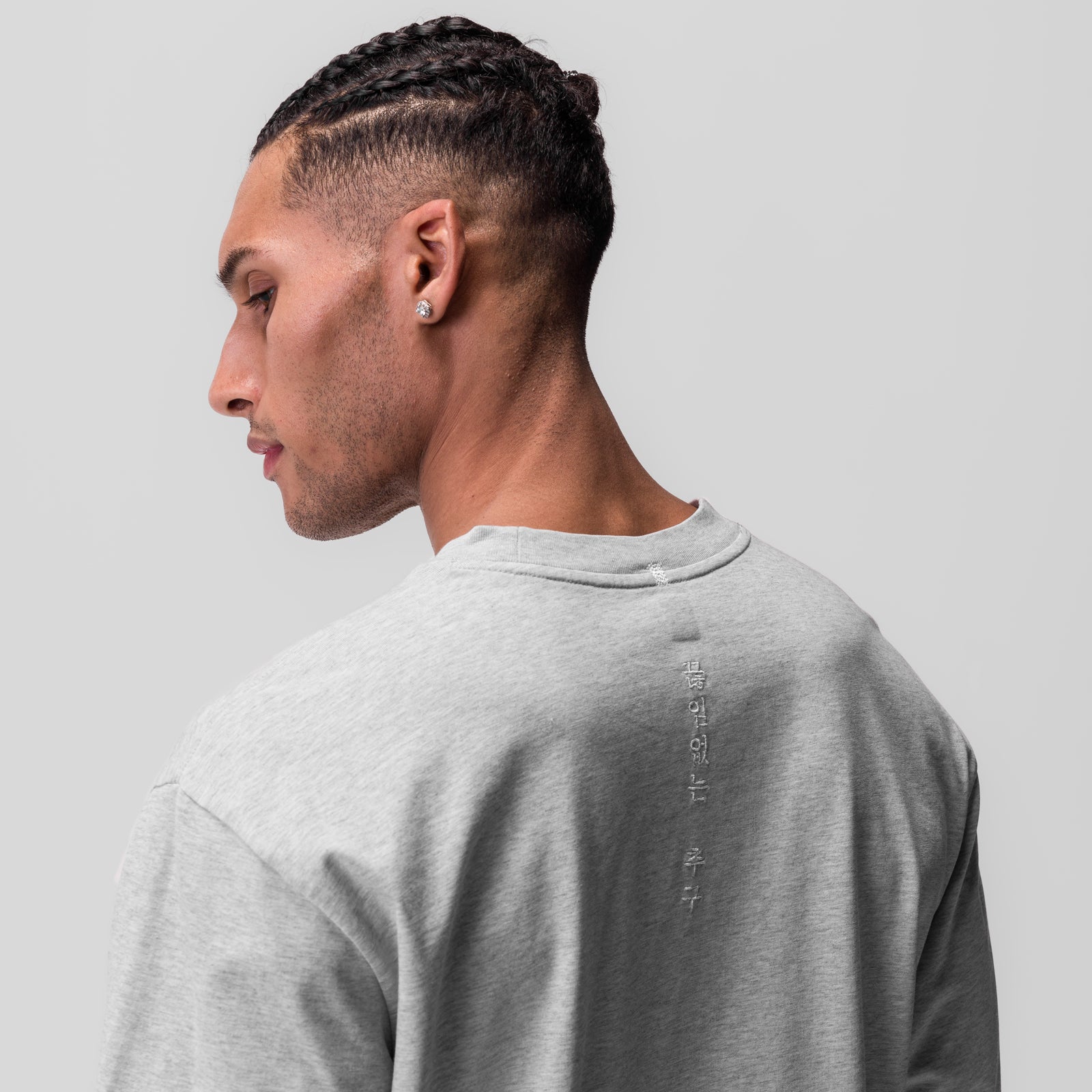 Tech Essential Relaxed Long Sleeve in heather grey, worn by model in profile view
