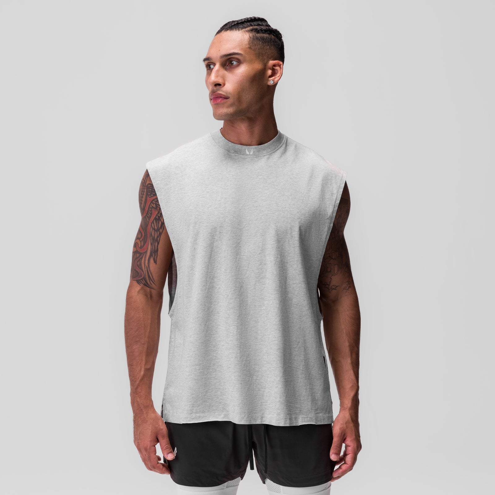 Tech Essential Rocker Cutoff sleeveless tank in heather grey, worn by model, front view