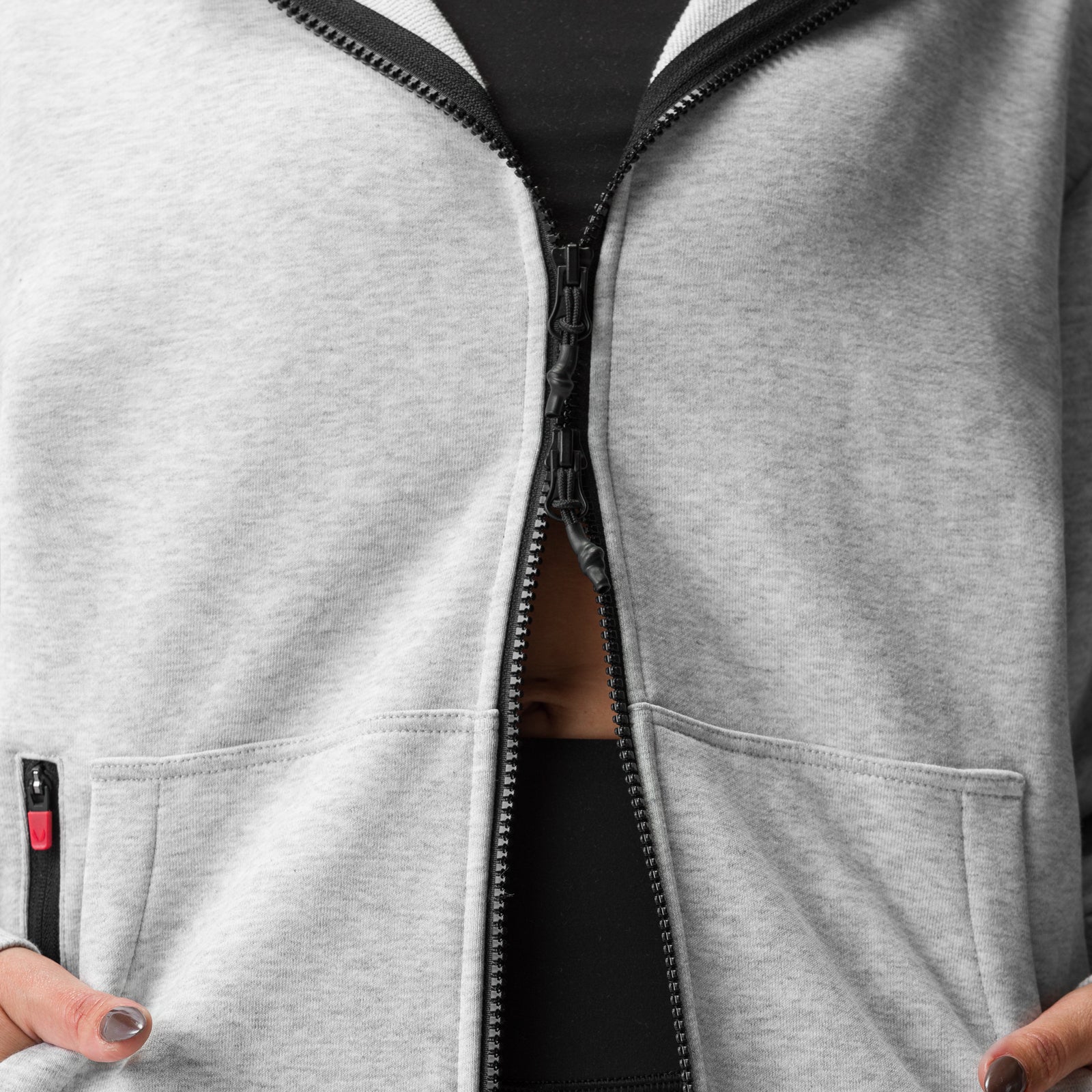 Heather grey oversized zip hoodie worn open, showing black inner layer and front pockets