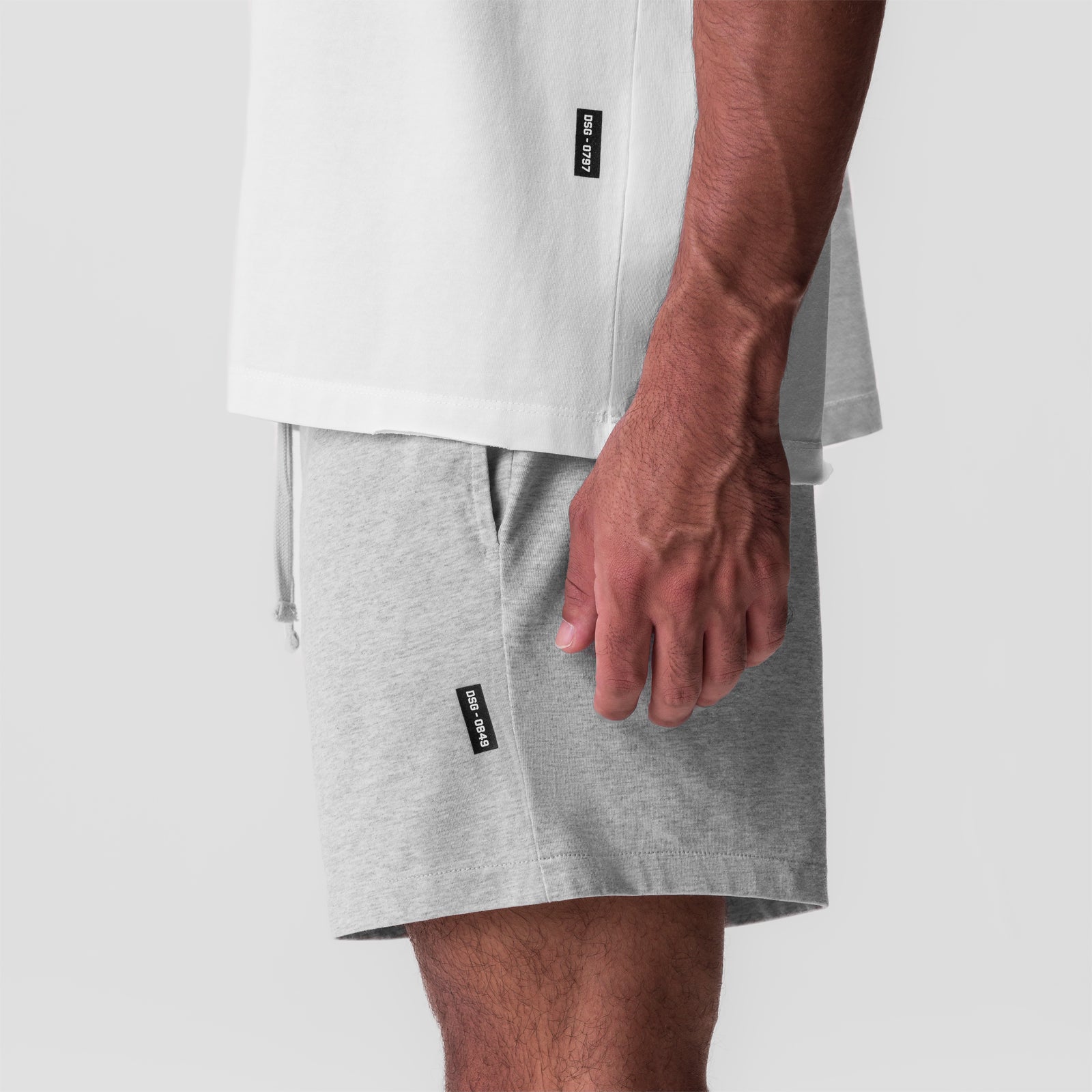 Tech Essential Sweat Short in heather grey worn by model, side view