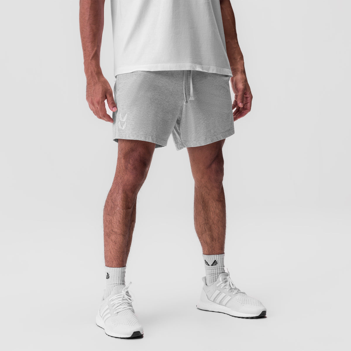 Tech Essential Sweat Short in Heather Grey, modeled with white tee and sneakers