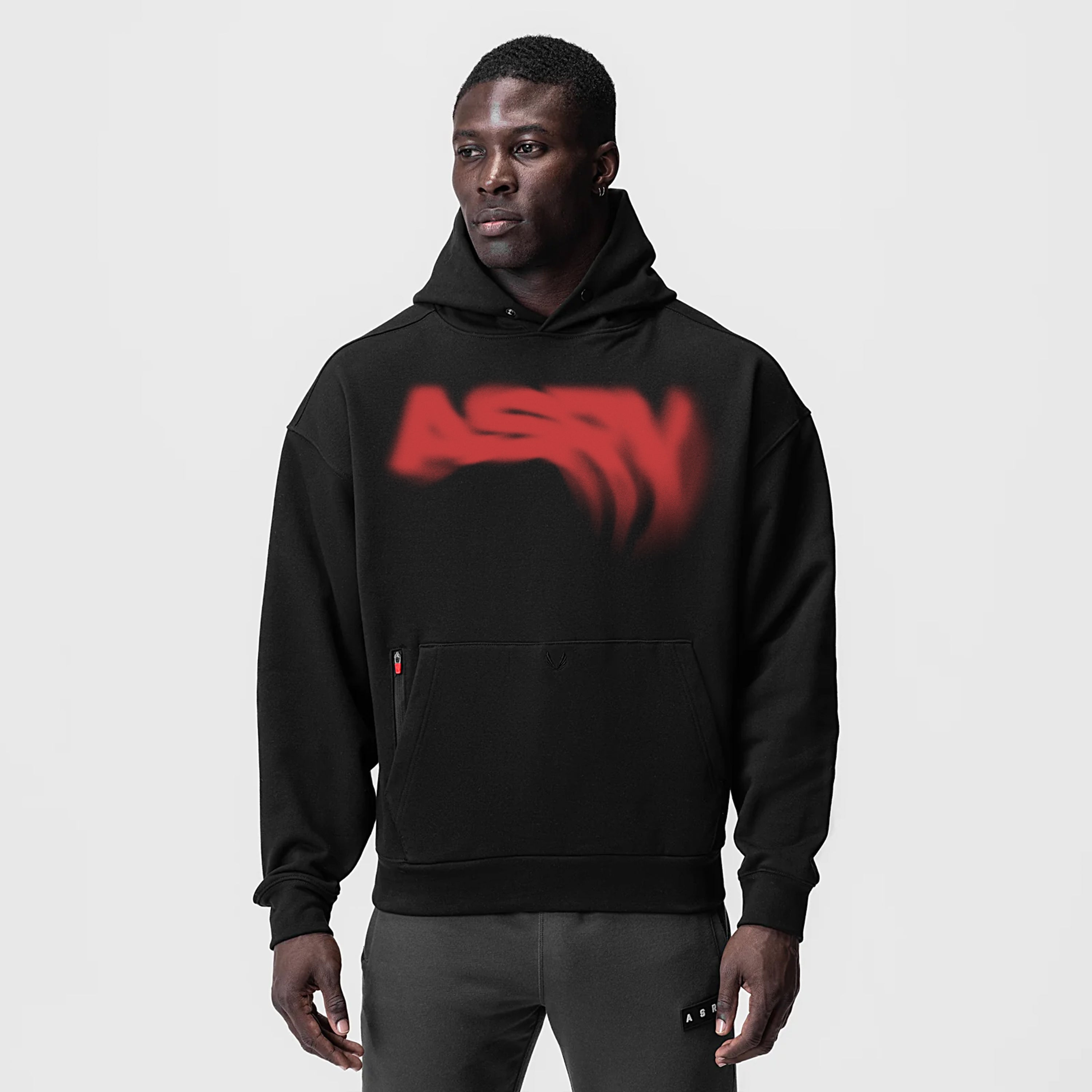 Tech-Terry Zip Pocket Hoodie in black with red graphic logo, worn by model
