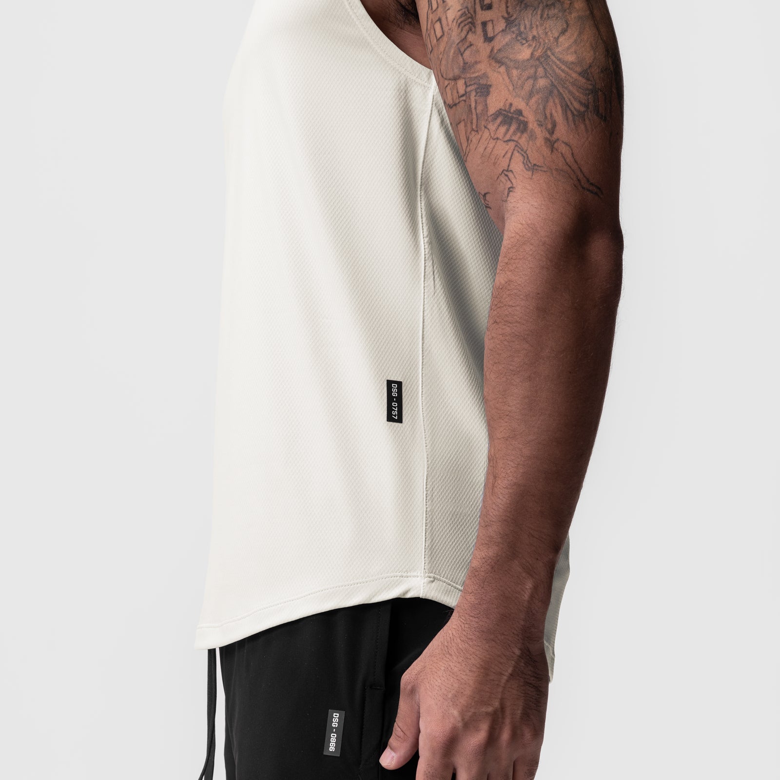 AeroSilver Cutoff Tank in ivory cream worn by model, side view showing fit