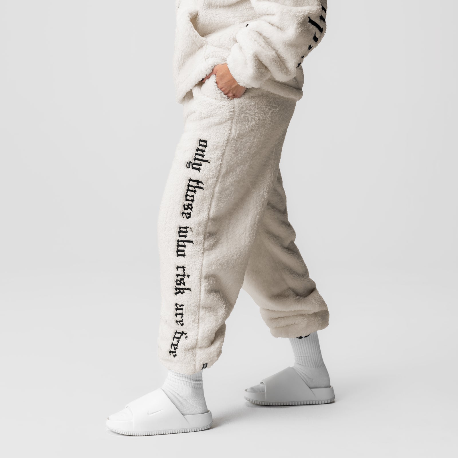 Womens Sherpa Recovery Sweats in ivory cream with black text, worn by model showing side view