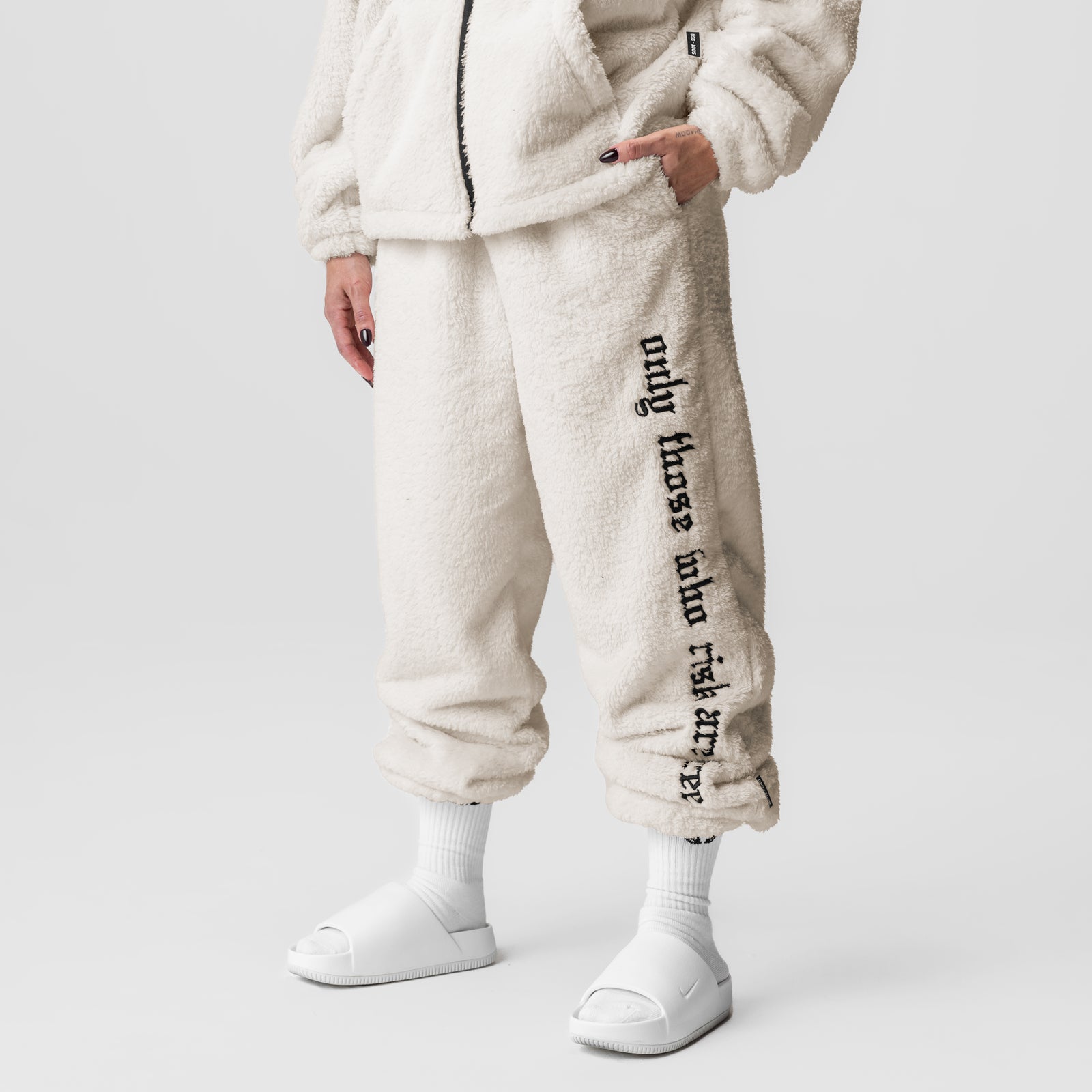 Womens Sherpa Recovery Sweats in ivory cream with black text detail, worn with white socks and slides