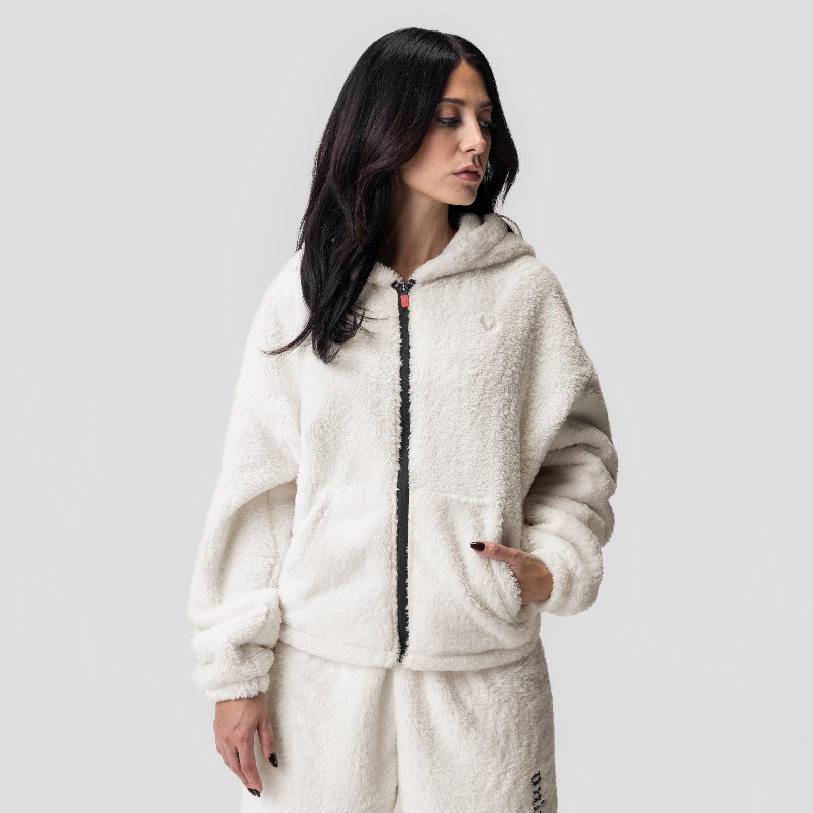 Women's Sherpa Recovery Full Zip Hoodie in ivory cream, worn by model in side profile
