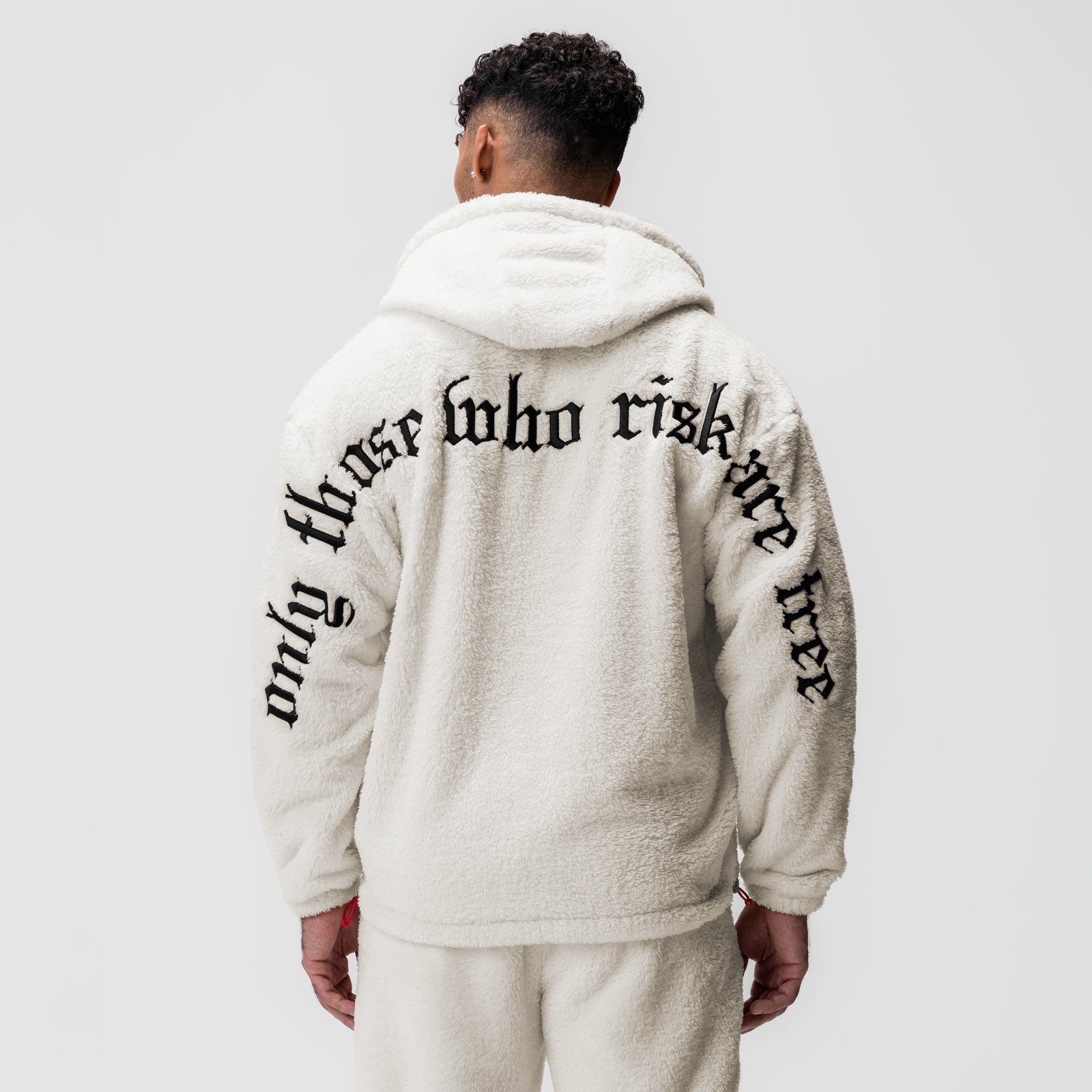 Sherpa Recovery Hoodie in ivory cream worn by model from back, showing text detail on hood