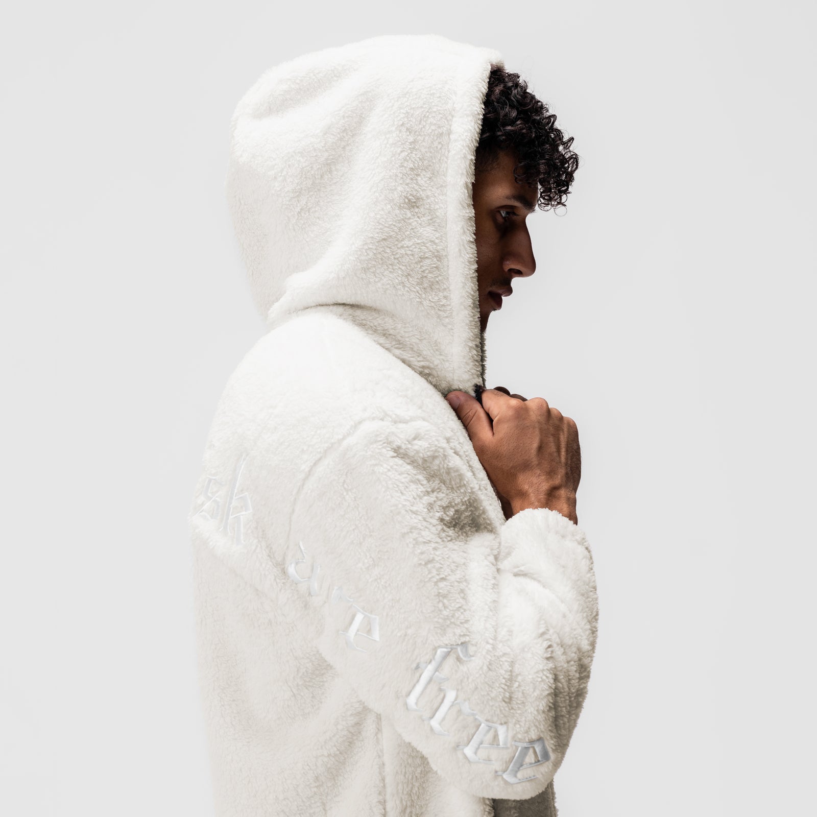 Sherpa Recovery Full Zip Hoodie in ivory cream, worn by model in profile view