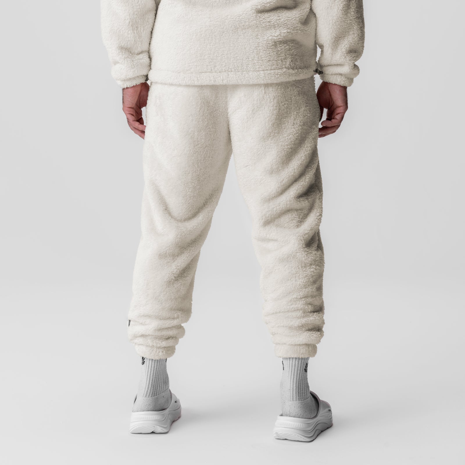 Sherpa Recovery Sweats in ivory cream worn by model, back view showing jogger fit and cuffed ankles
