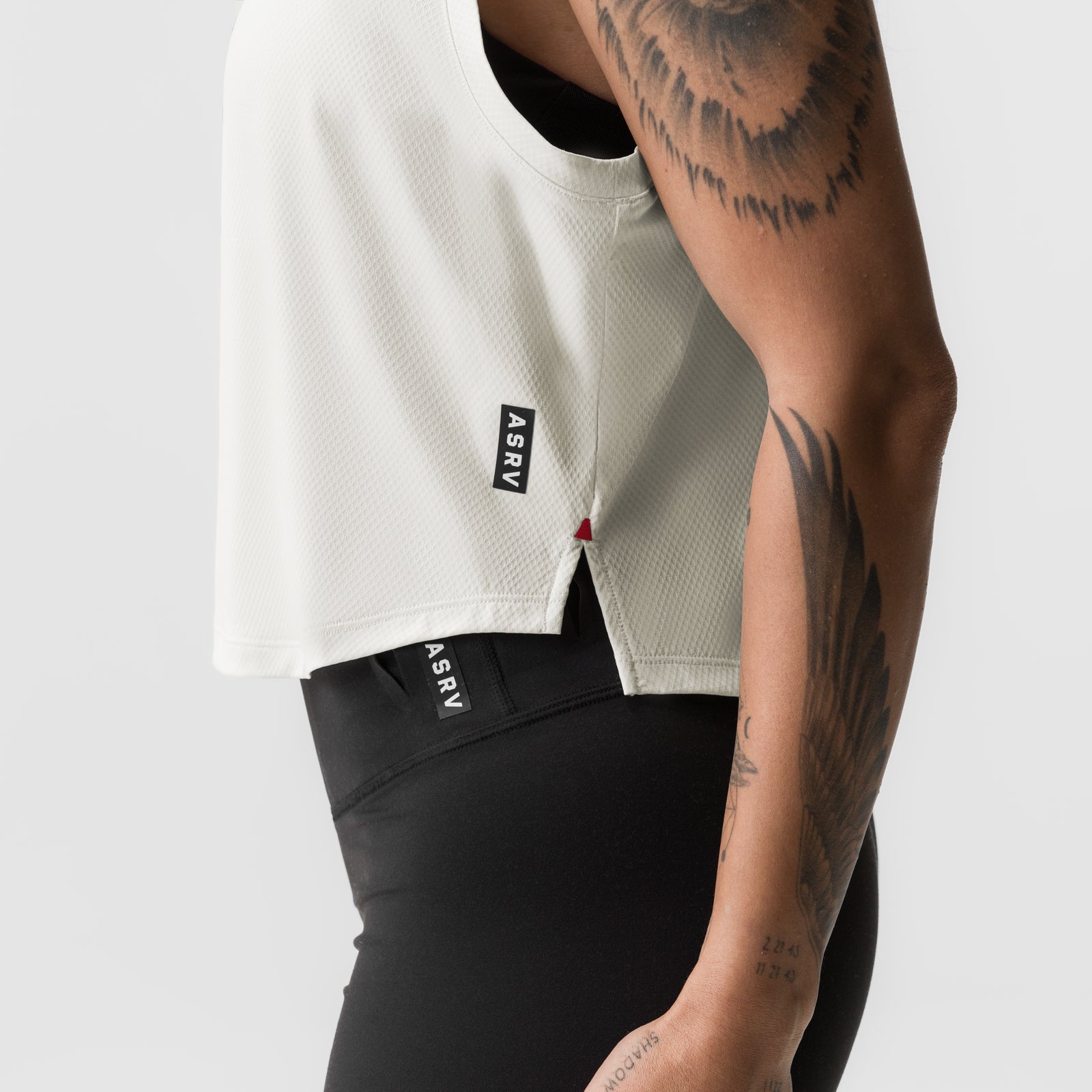 AeroSilver® Cropped Training Tank in Ivory Cream worn by model, side view