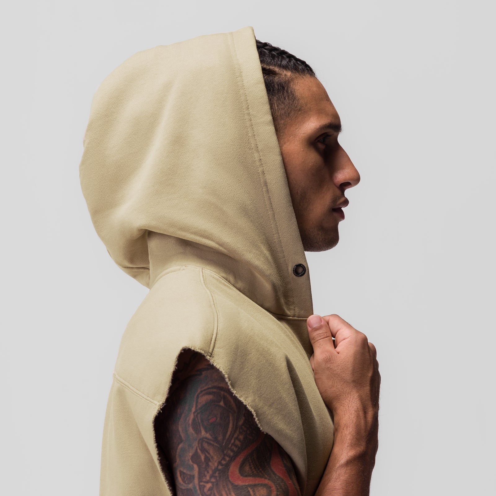 Tech Essential Raw Hem Cutoff Hoodie in khaki, worn by model in profile view