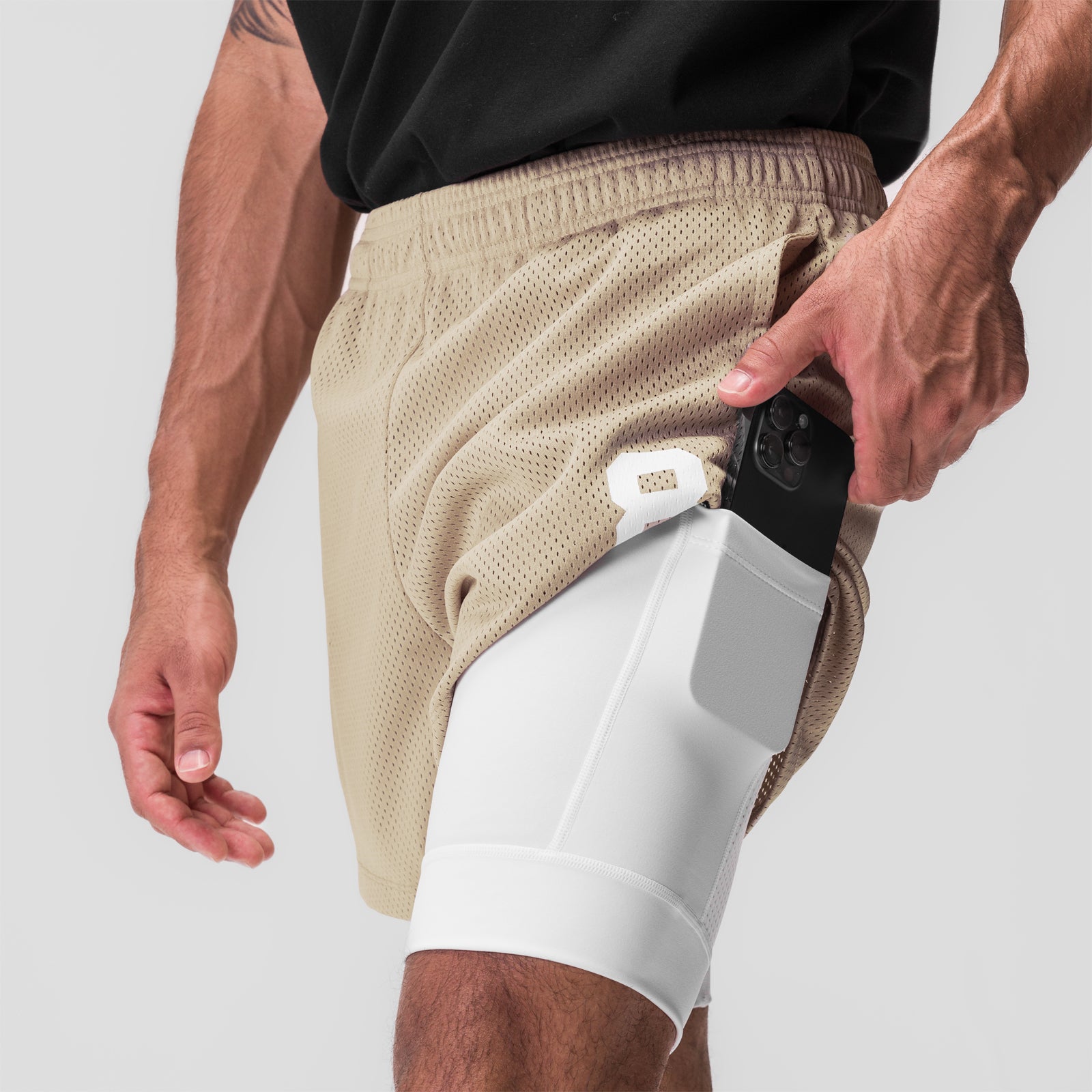 SilverPlus Mesh 5" Liner Short in Khaki/White, model wearing shorts with phone in pocket