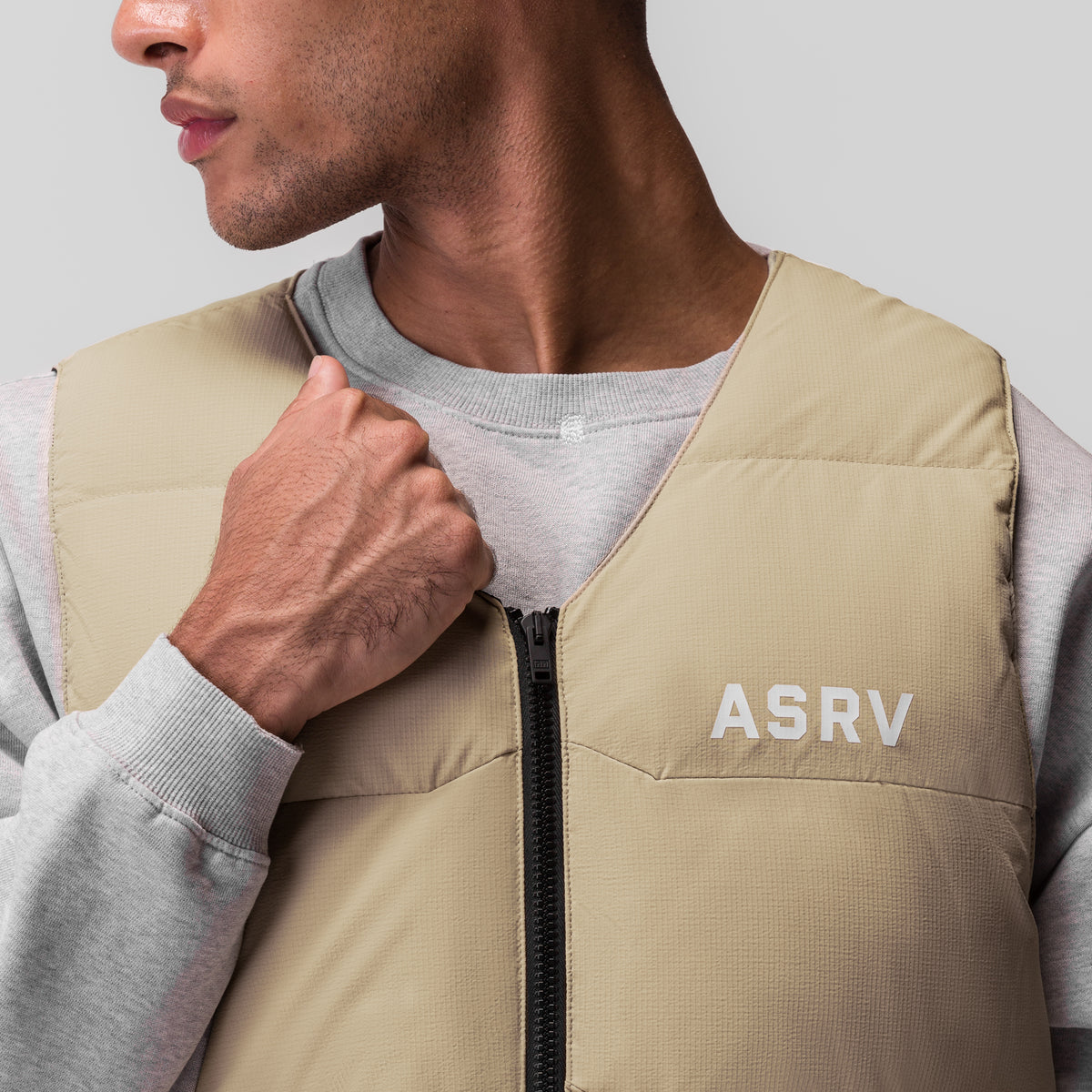Ripstop Insulated Puffer Gilet in khaki, worn by model, front view with zip detail
