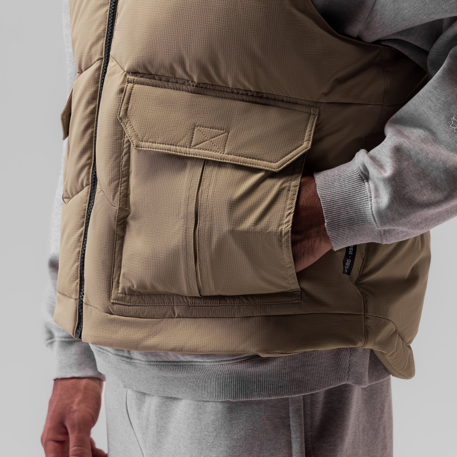 Ripstop Insulated Puffer Gilet in khaki worn by model, side view showing cargo pocket detail