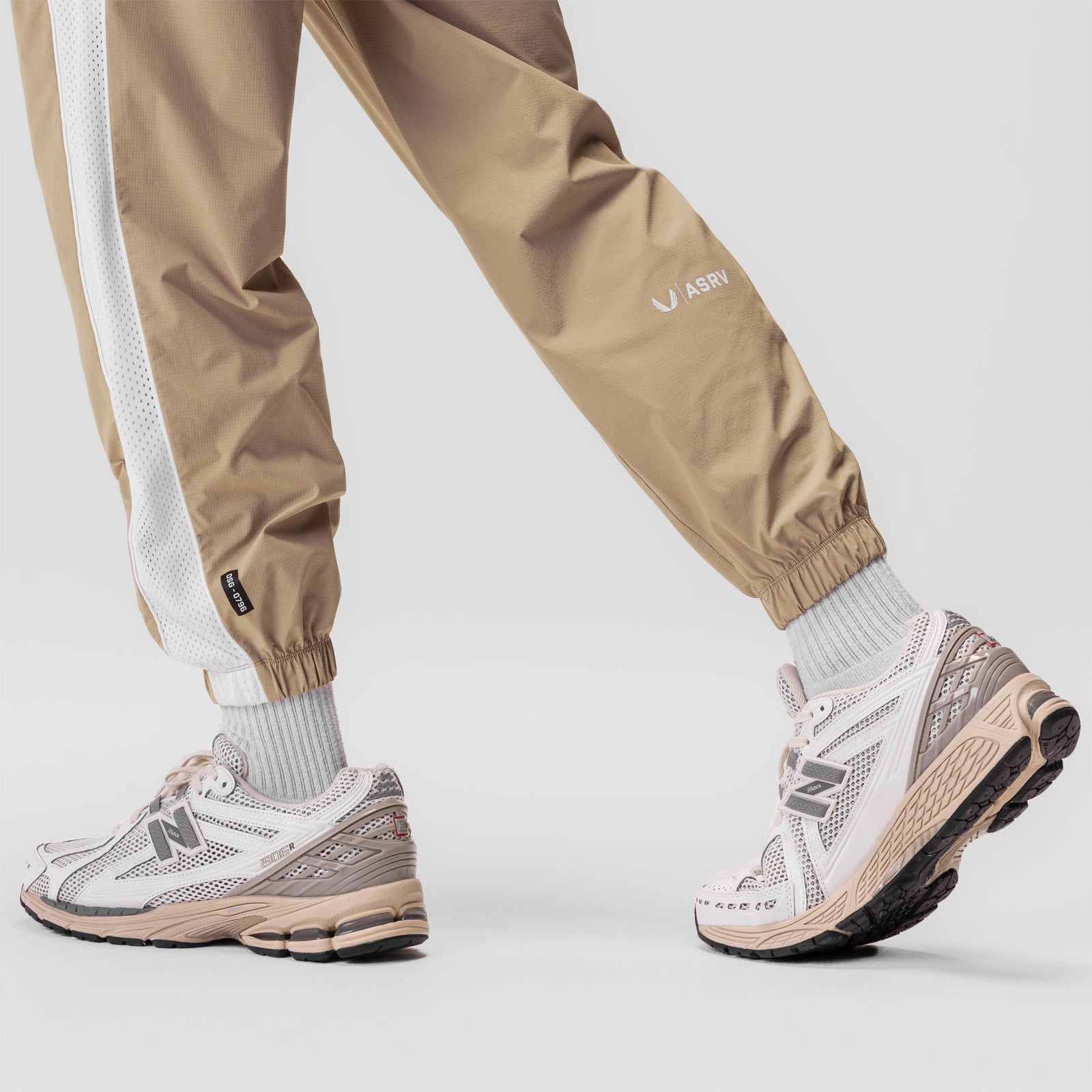 Ripstop Oversized Track Pant in khaki worn with white socks and sneakers, side view