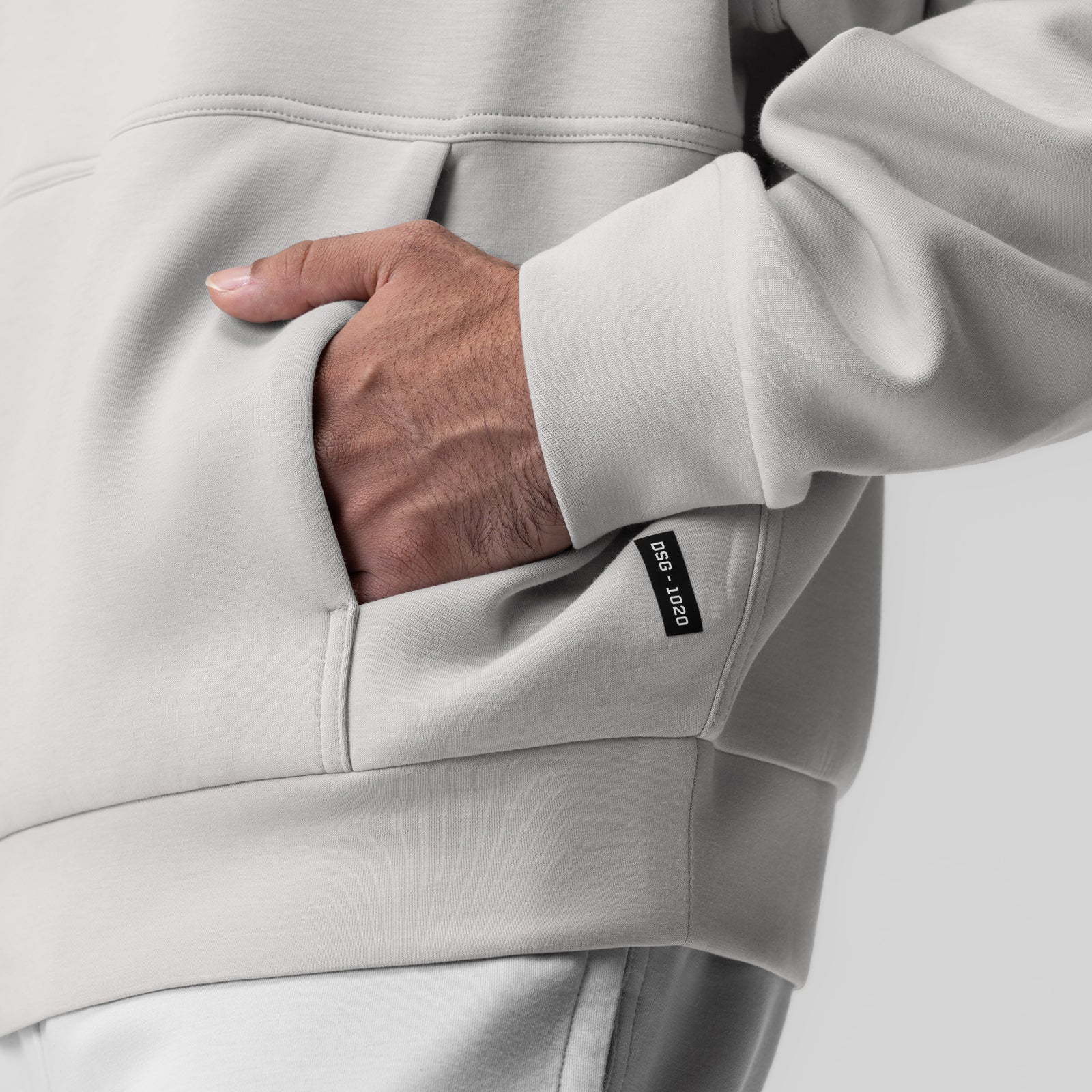 Dri-Core Oversized Crewneck in light grey, worn with hand in kangaroo pocket
