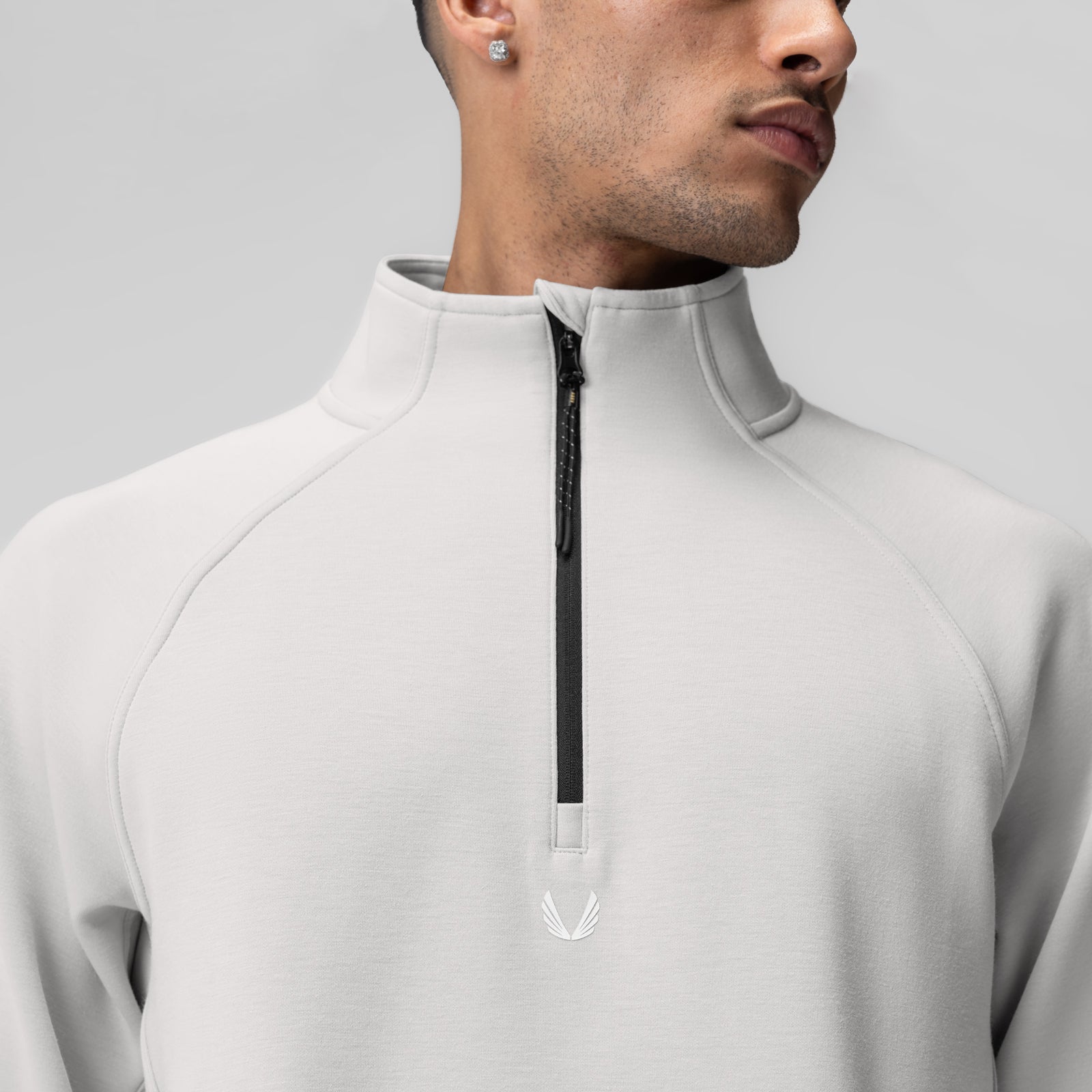 Dri-Core Quarter Zip in light grey worn by model, front view showing zippered neckline