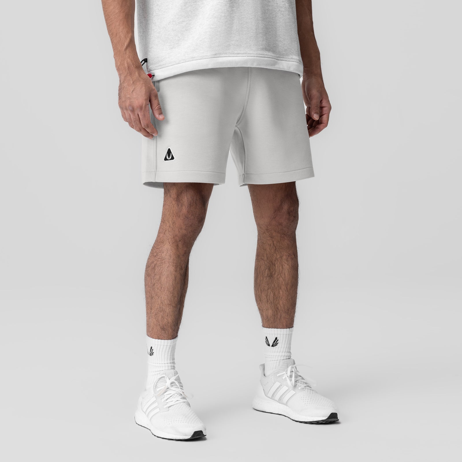 Dri-Core™ Training Short in light grey, worn by model with white socks and sneakers, front view