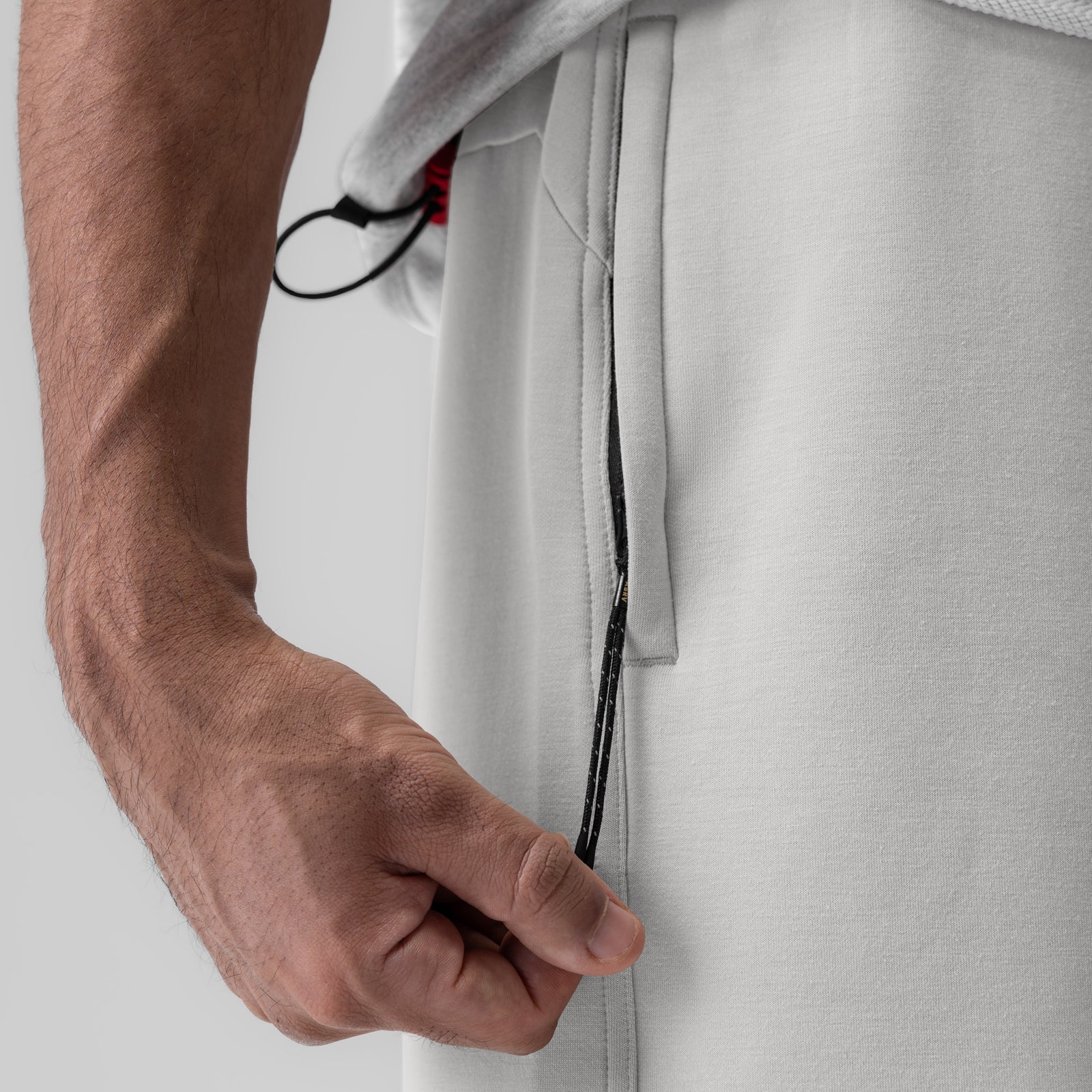 Dri-Core Training Short in light grey, model wearing shorts with hand in pocket detail