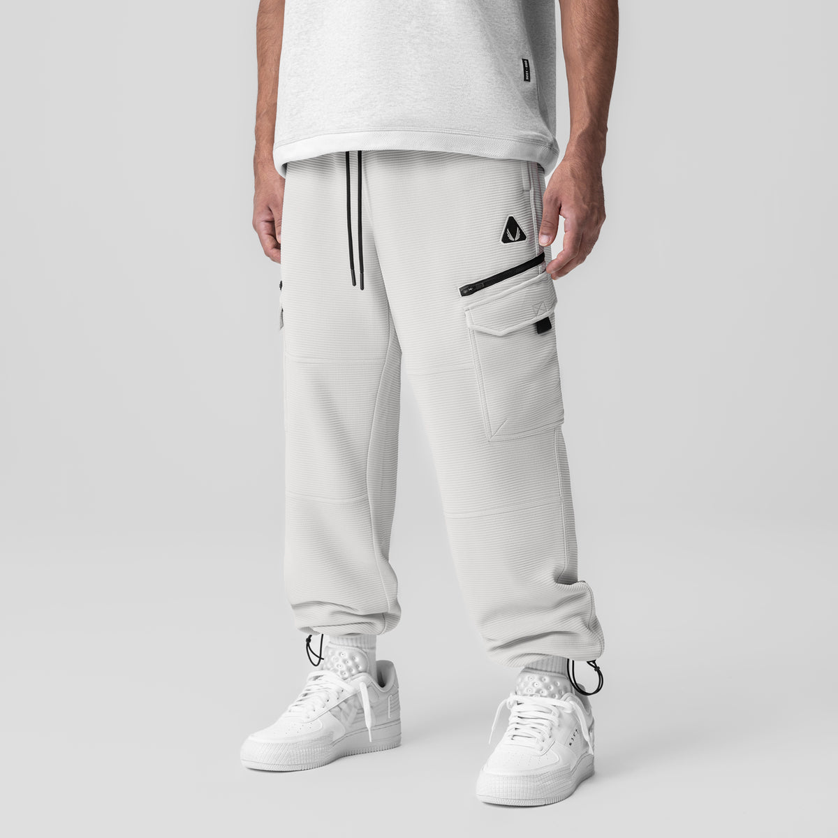 Deltapeak® Cargo Cinch Jogger in light grey, worn by model with white sneakers, front view