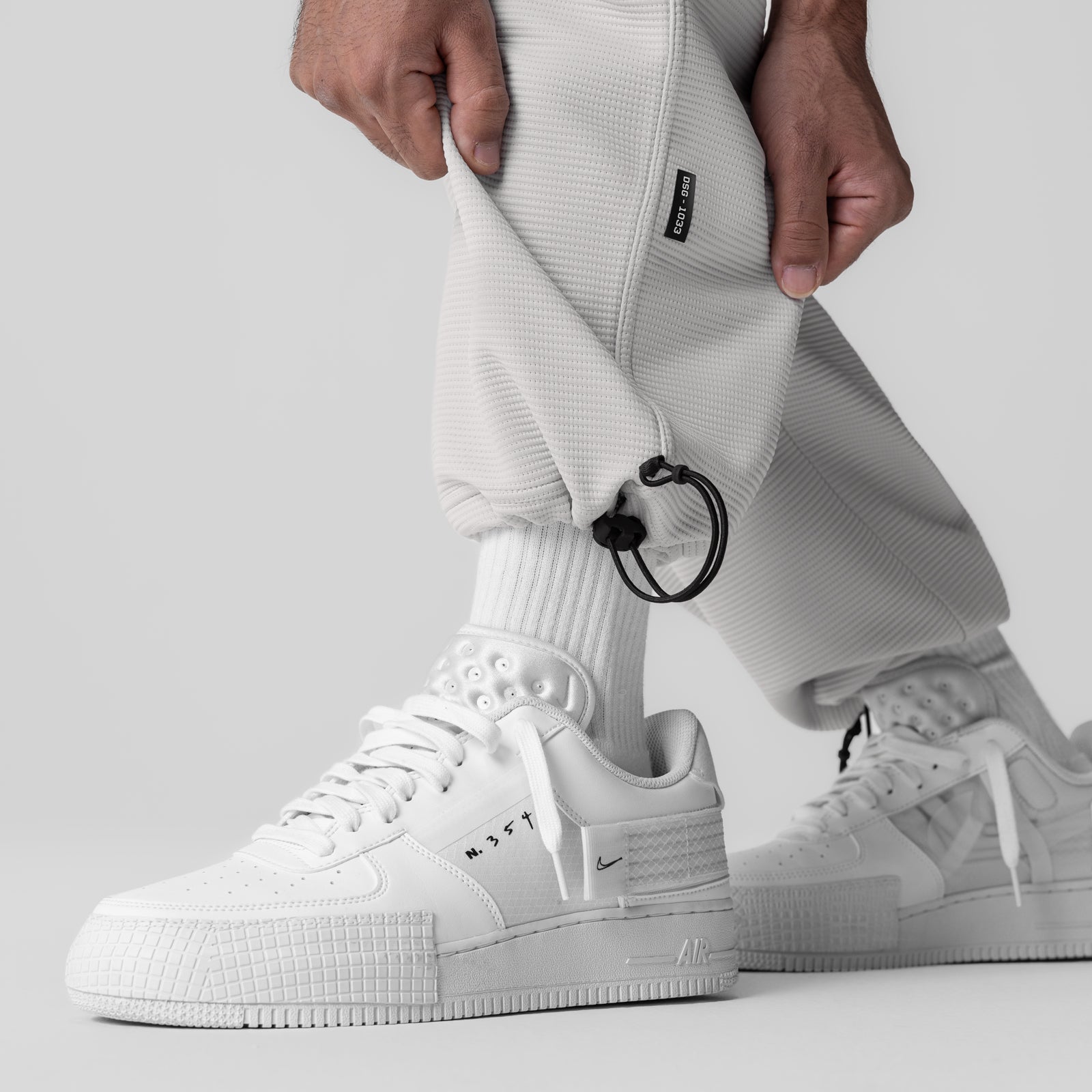 Deltapeak® Cargo Cinch Jogger in light grey worn with white sneakers, side view