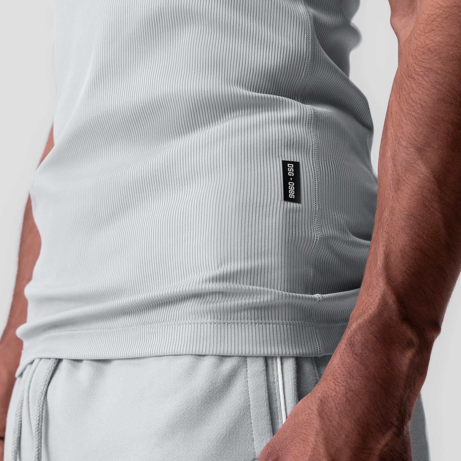 Creora® Tech Ribbed Tank in light grey, worn by model showing side view